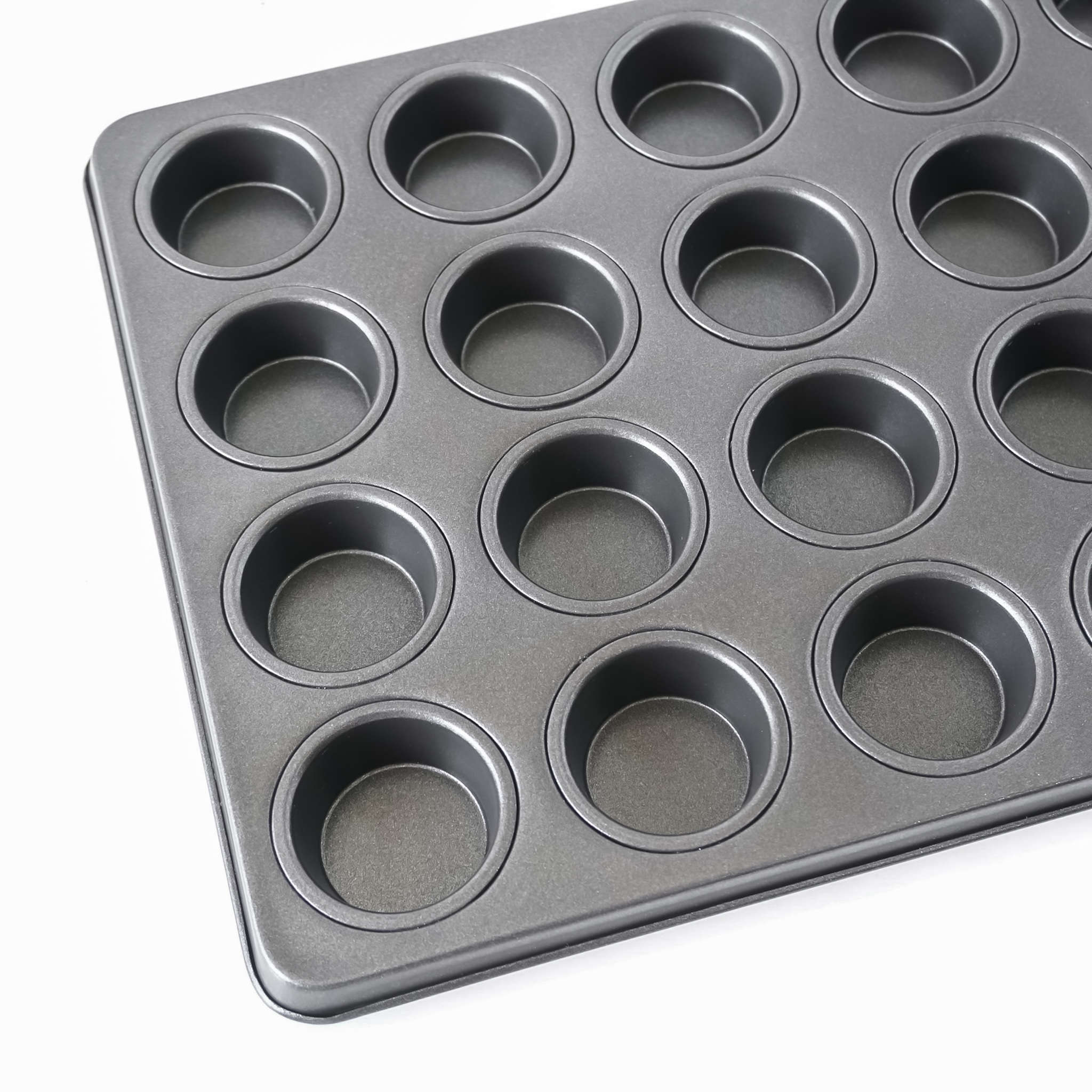 Black muffin pan with multiple compartments on a white background