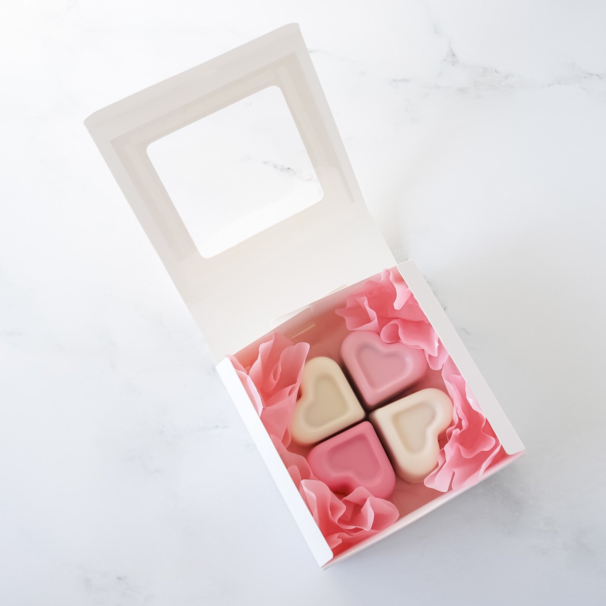 Heart-shaped cookies in a gift box on a white background