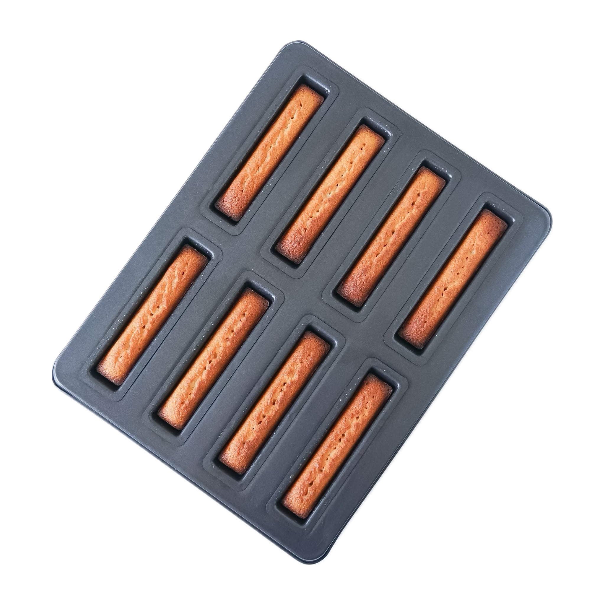 A black financier cake pan with eight cavities, each shaped like a baton. The pan is made of cold-rolled steel with a nonstick coating.