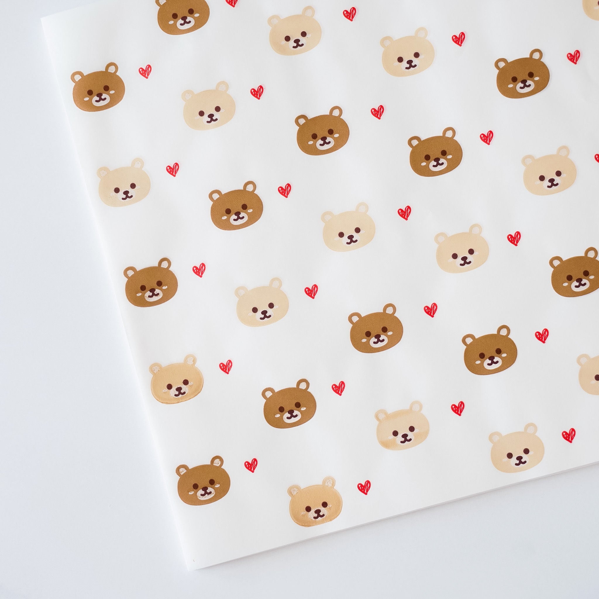 A sheet of mini deli paper with a bear and heart pattern.
