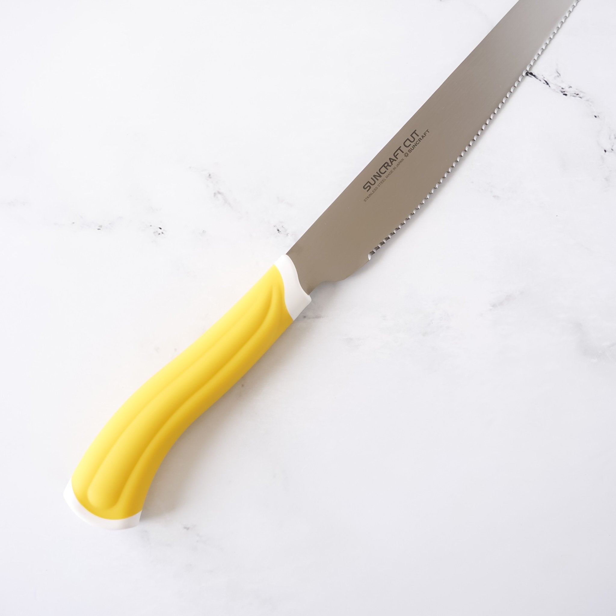 bread knife with resin handle in yellow