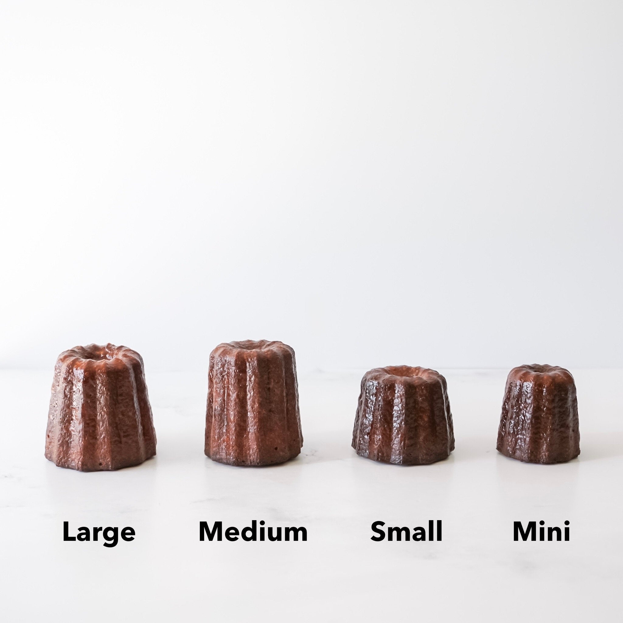 Four caneles labeled &