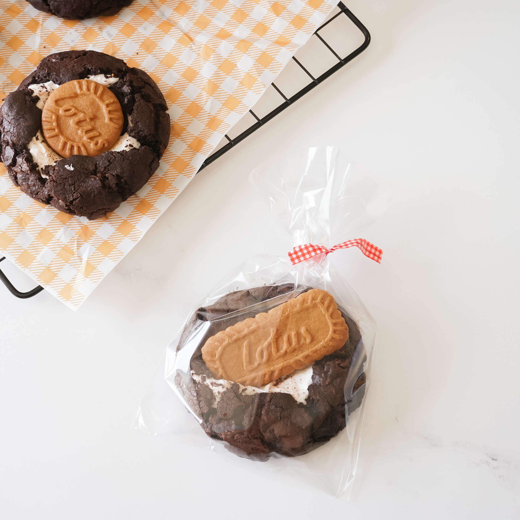 Clear flat cellophane bags with a twist-tie closure, displayed alongside cookies on a cooling rack.