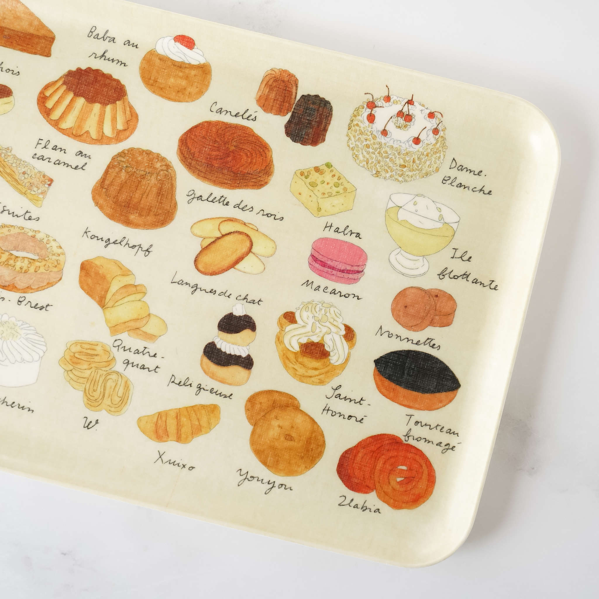 A medium-sized linen-covered serving tray with pastry-themed illustrations featuring various cakes and pastries.