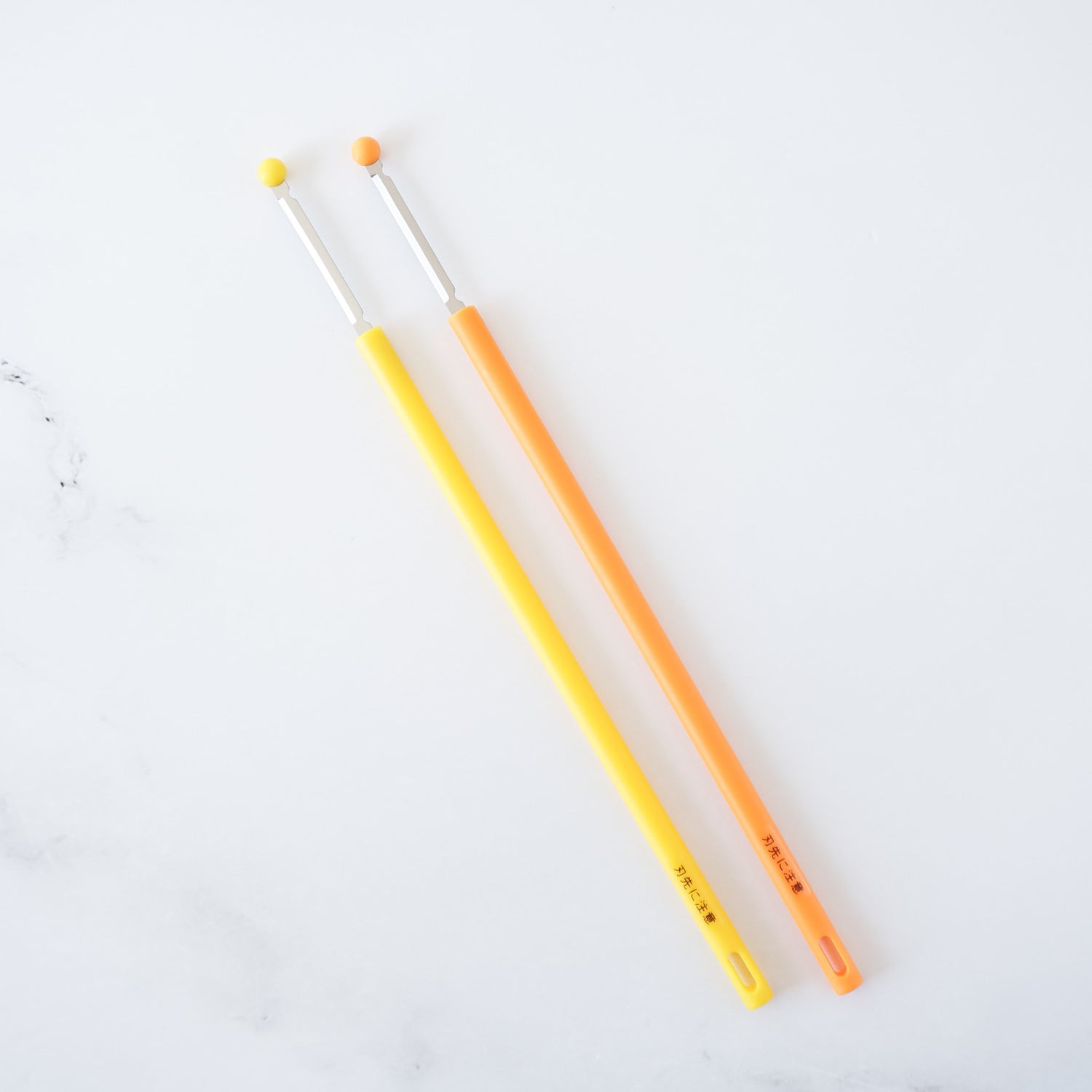 egg whisk sticks in yellow and orange