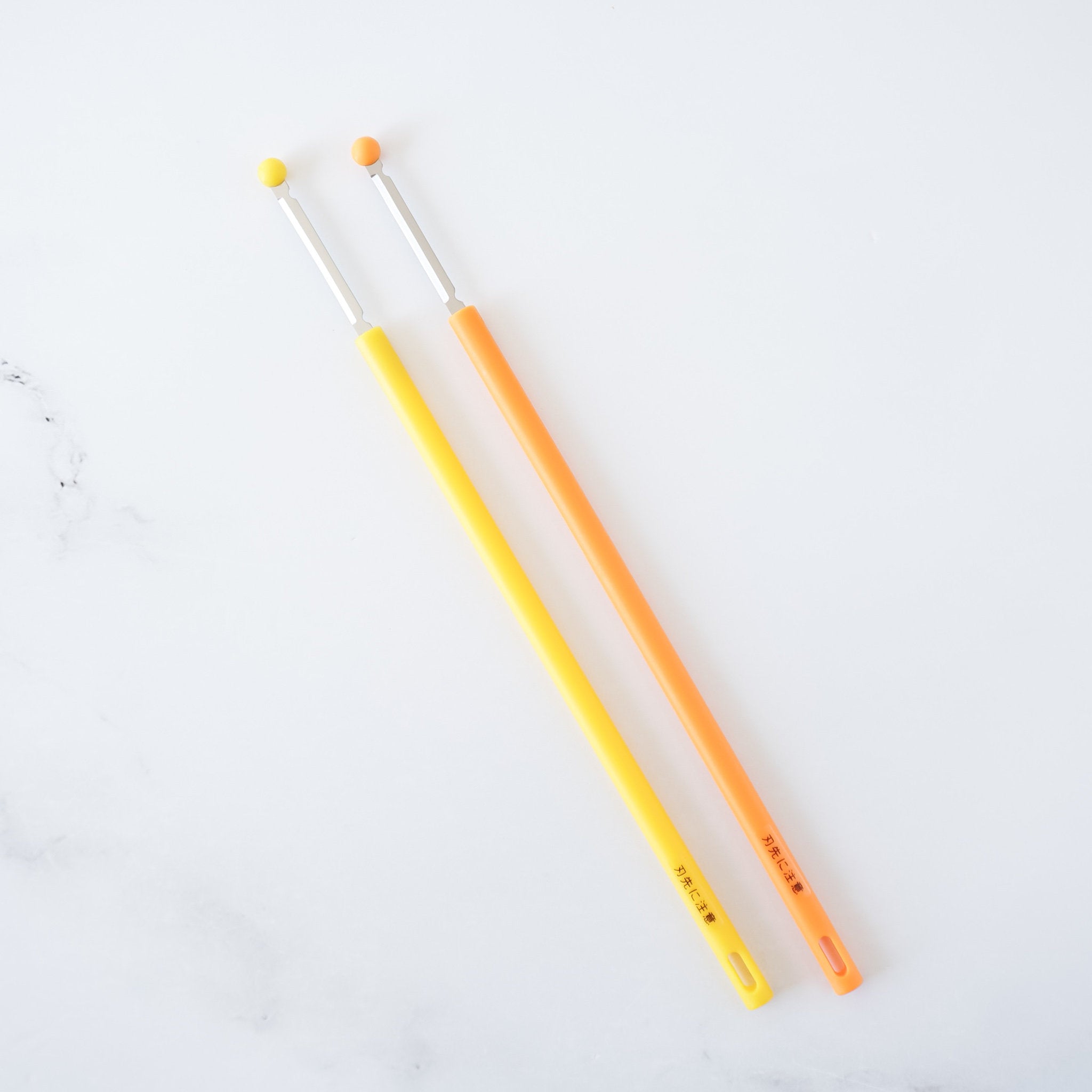 egg whisk sticks in yellow and orange