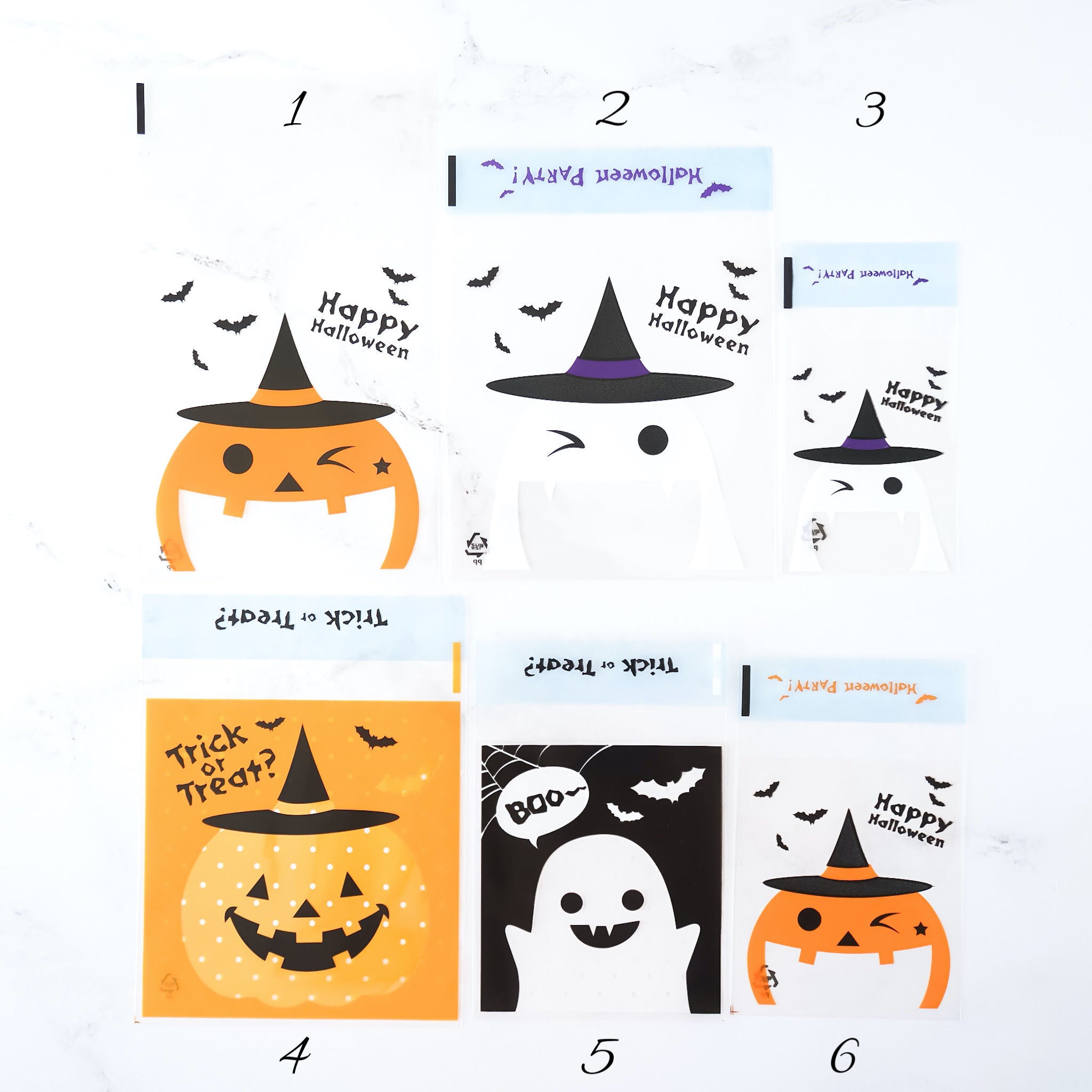 Assorted Halloween-themed cellophane bags with various designs including pumpkin, bat, ghost, and witch motifs.