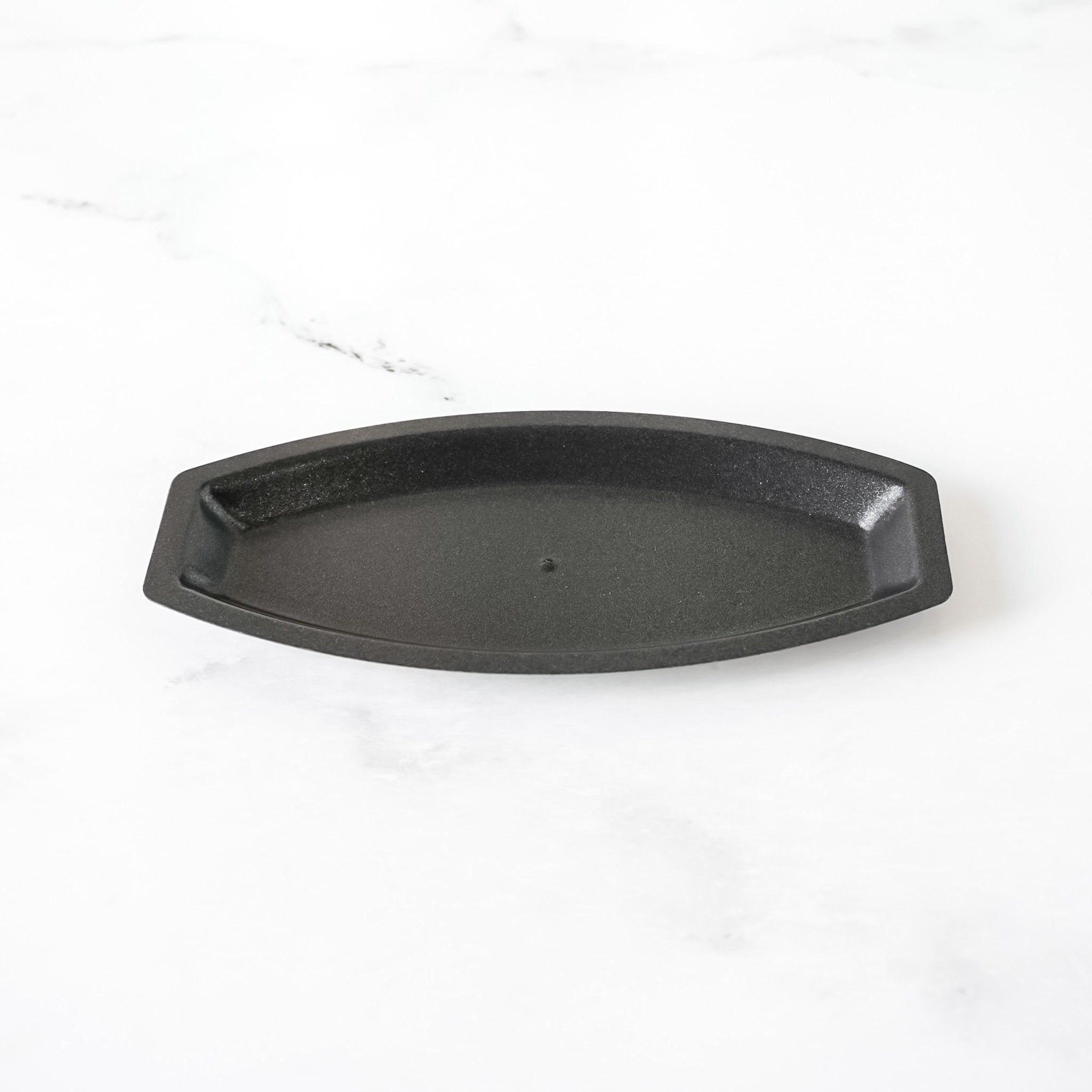 Black salt bread mold on a white background