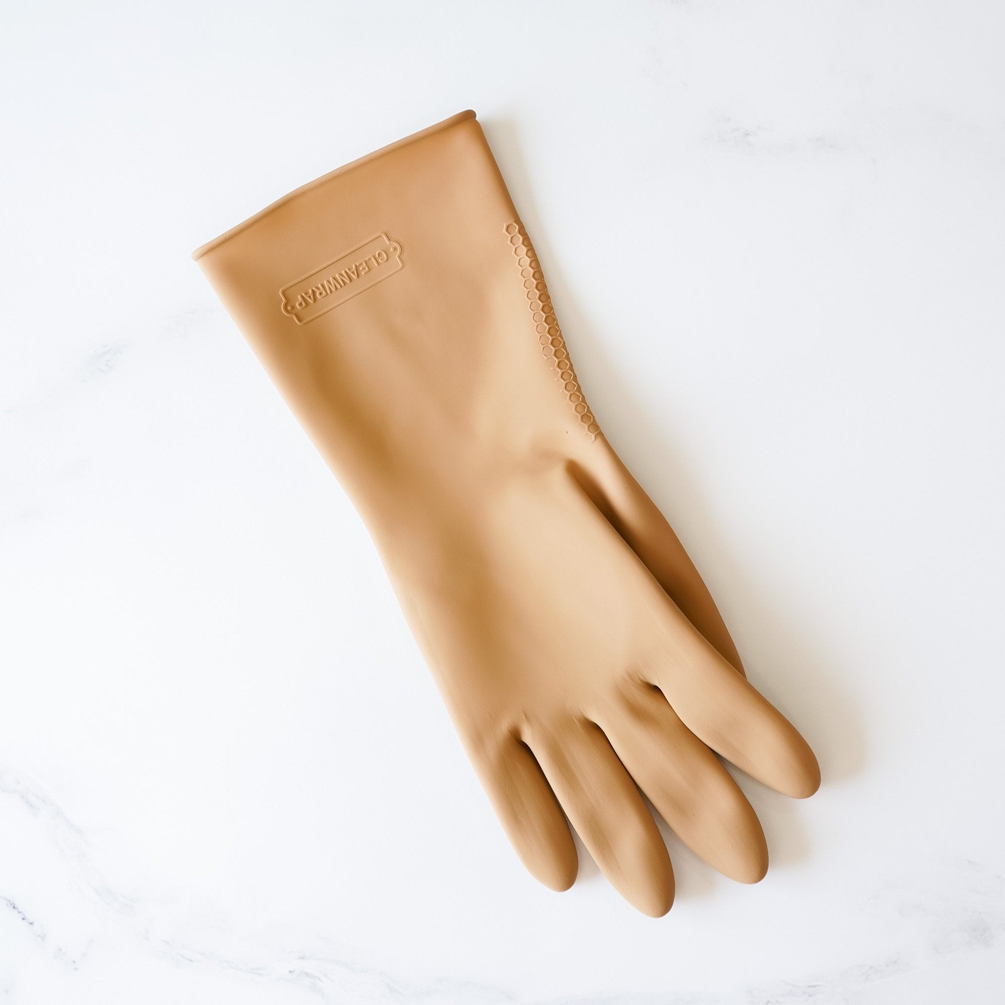 A tan rubber cleaning glove with a textured surface.