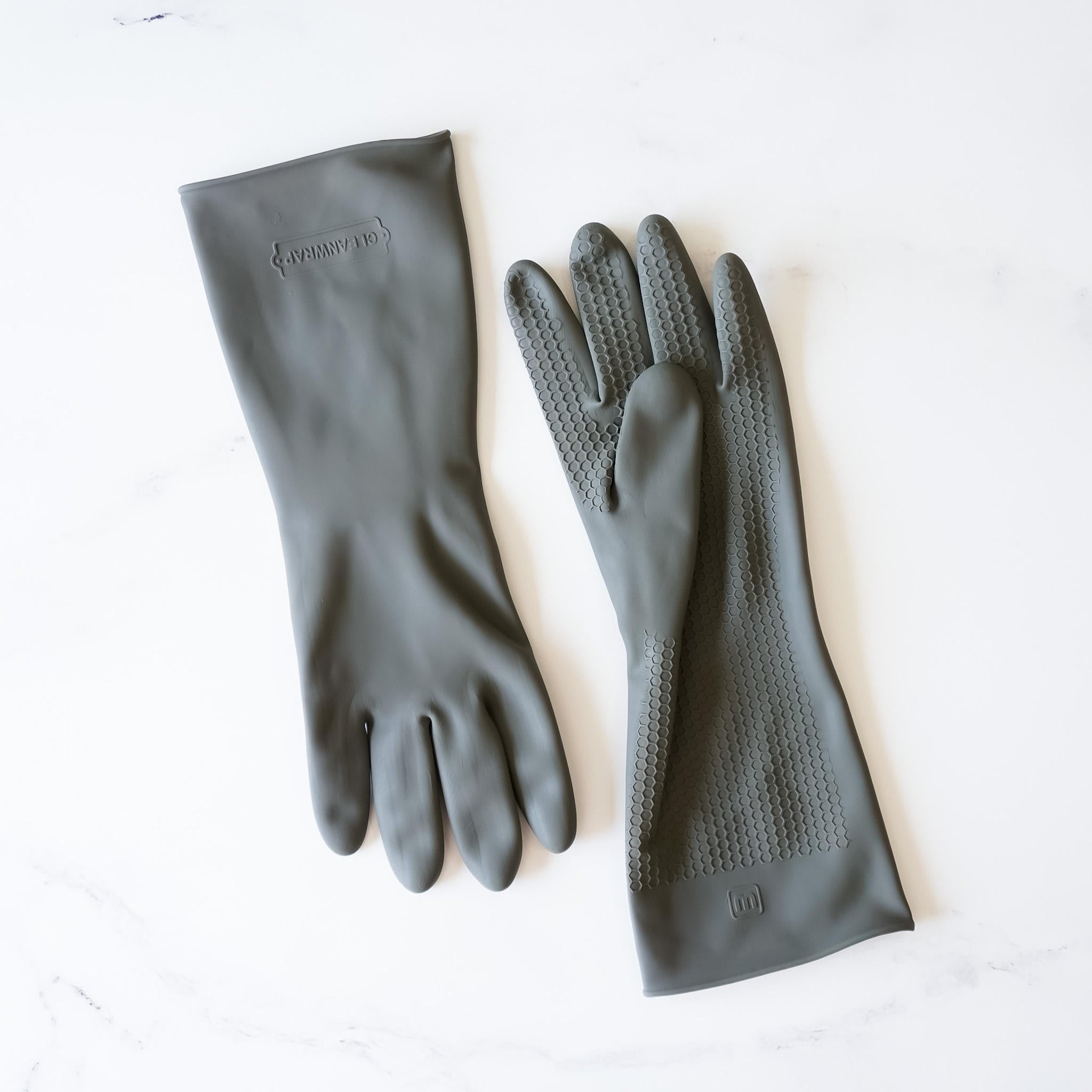 Two gray rubber dishwashing gloves with a textured surface. The gloves have a logo on the back that says &