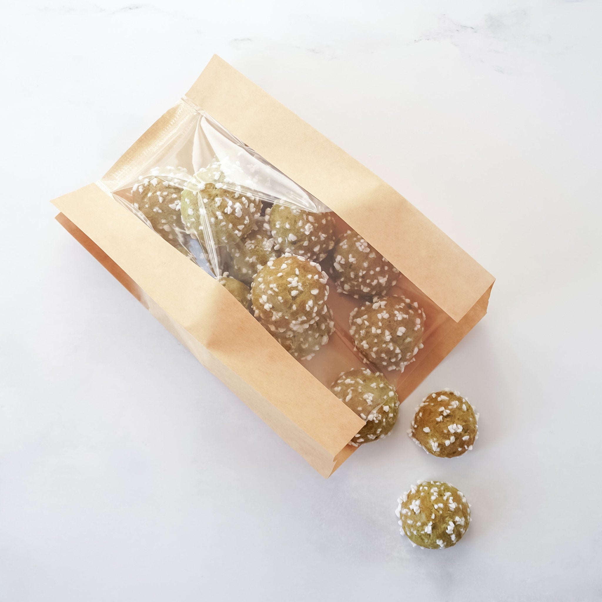 Packaged dessert balls with a clear window on a white background
