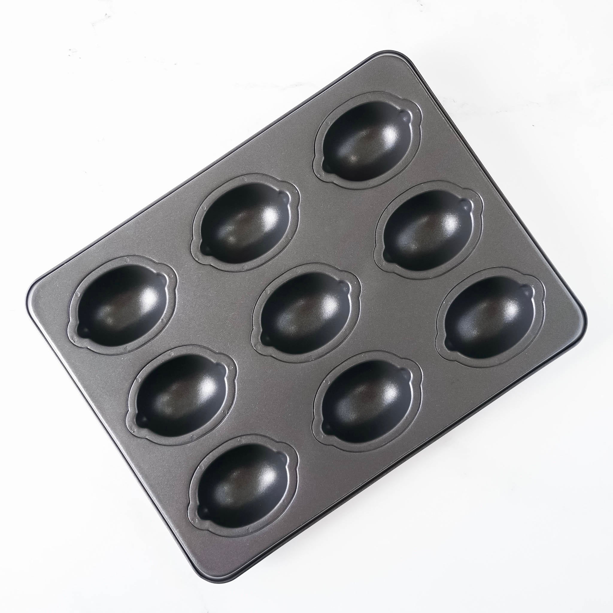 A black Lemon Cake Pan with nine cavities.