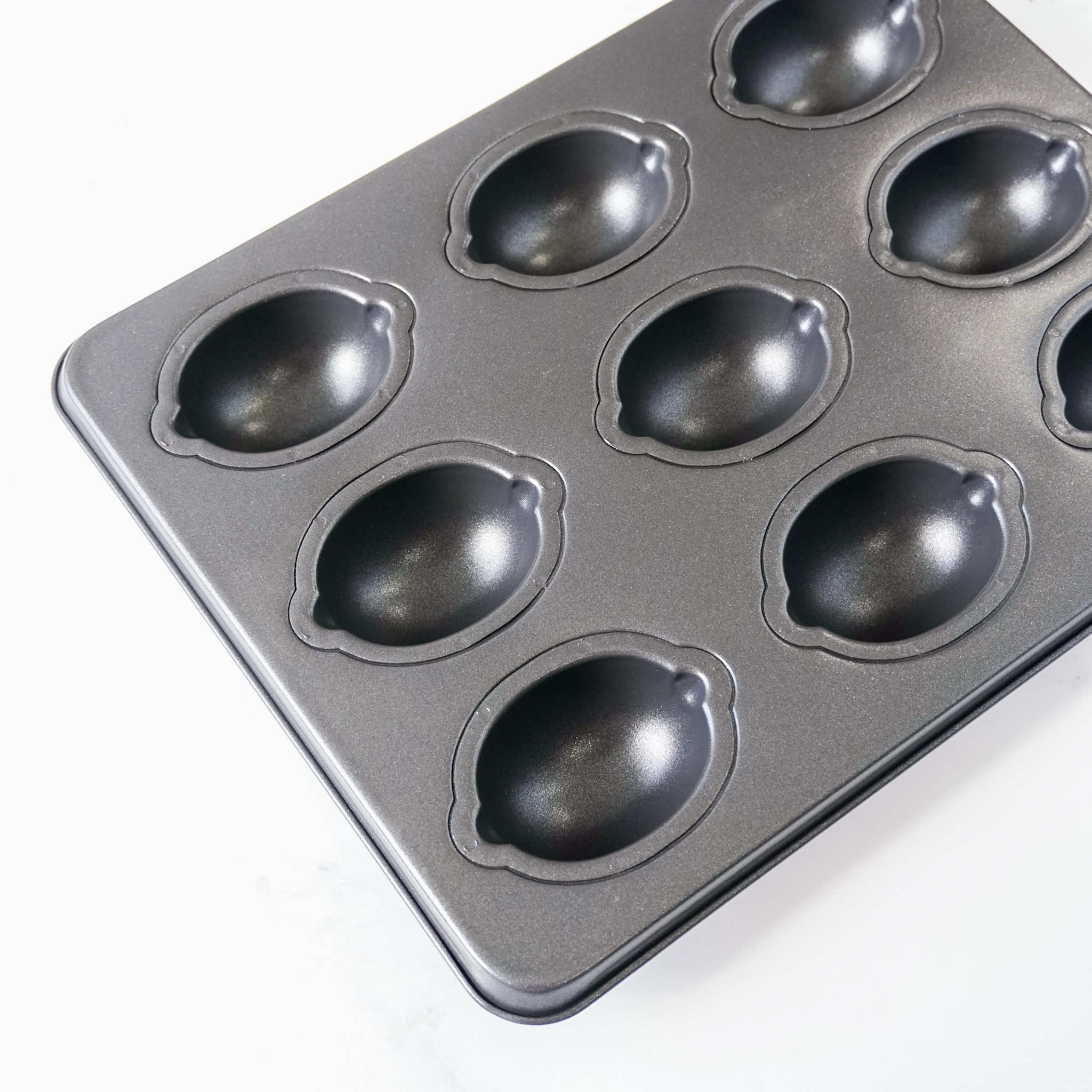 A black Lemon Cake Pan with nine cavities.