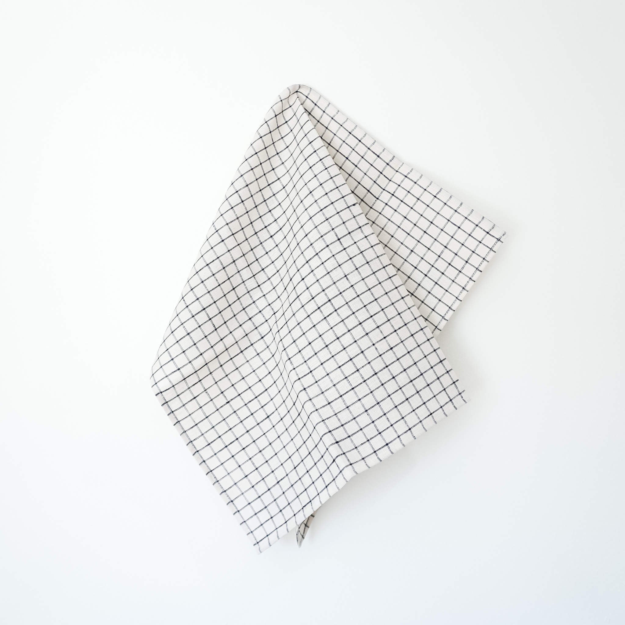 An ivory and black checkered linen dishcloth with a cotton hanging loop.