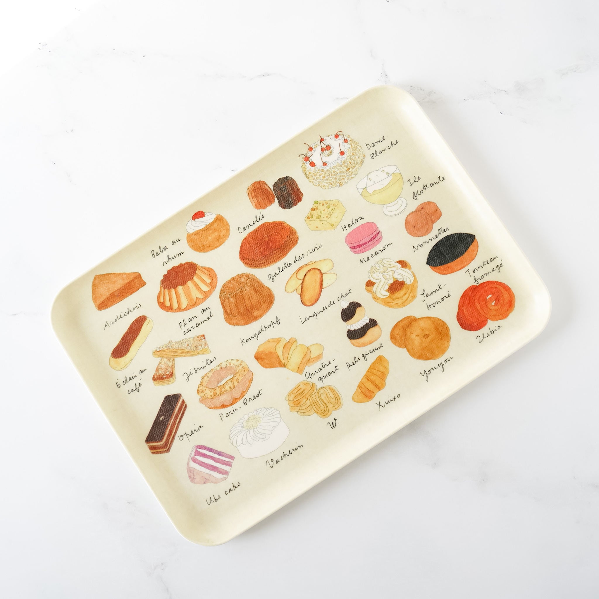 A medium-sized linen-covered serving tray with pastry-themed illustrations featuring various cakes and pastries.