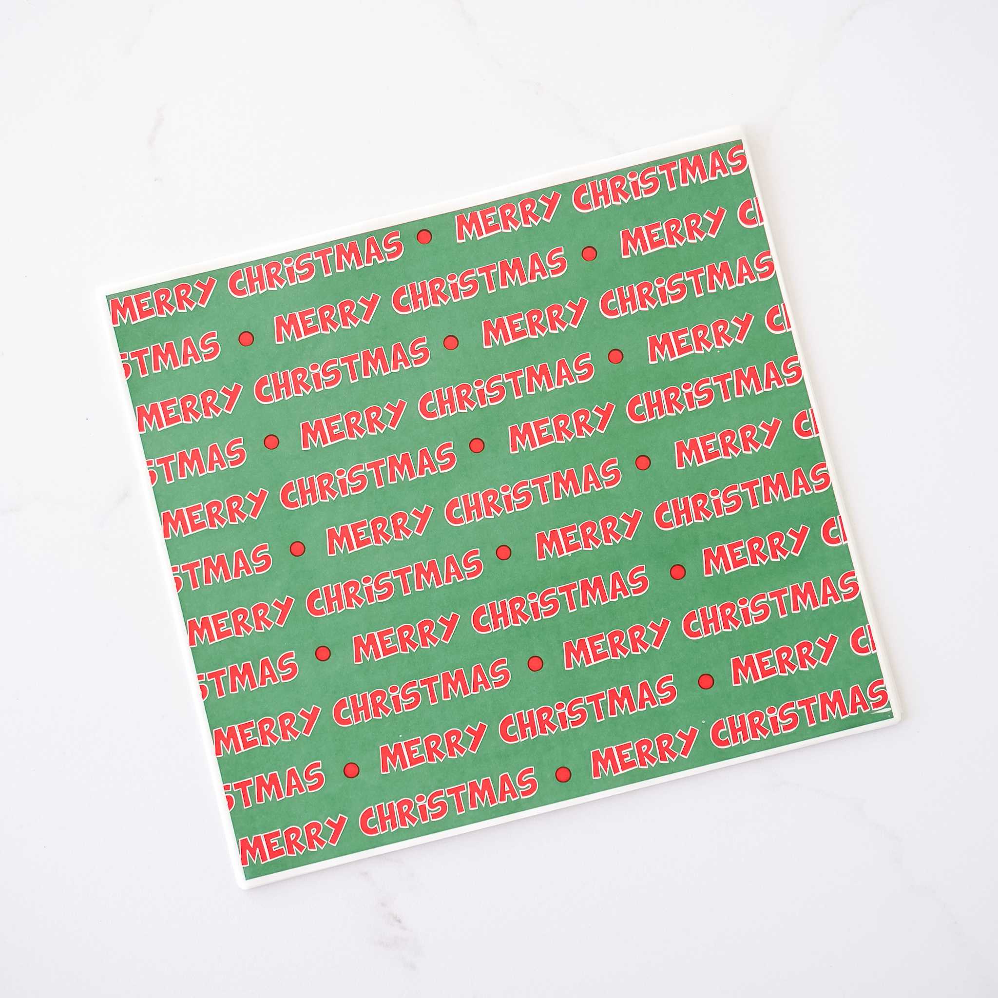 A sheet of deli paper with a green background and &