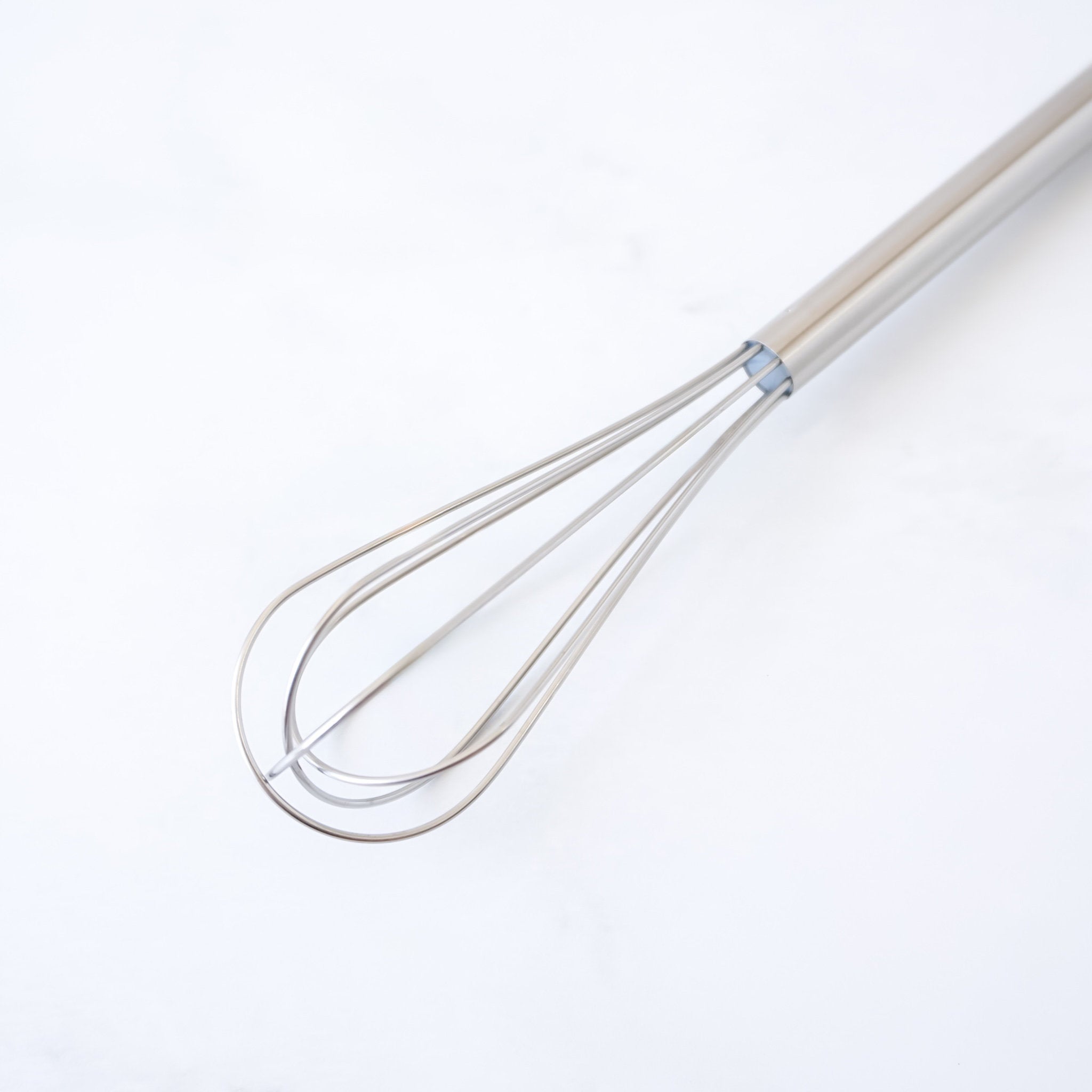 Mini whisk on a white background