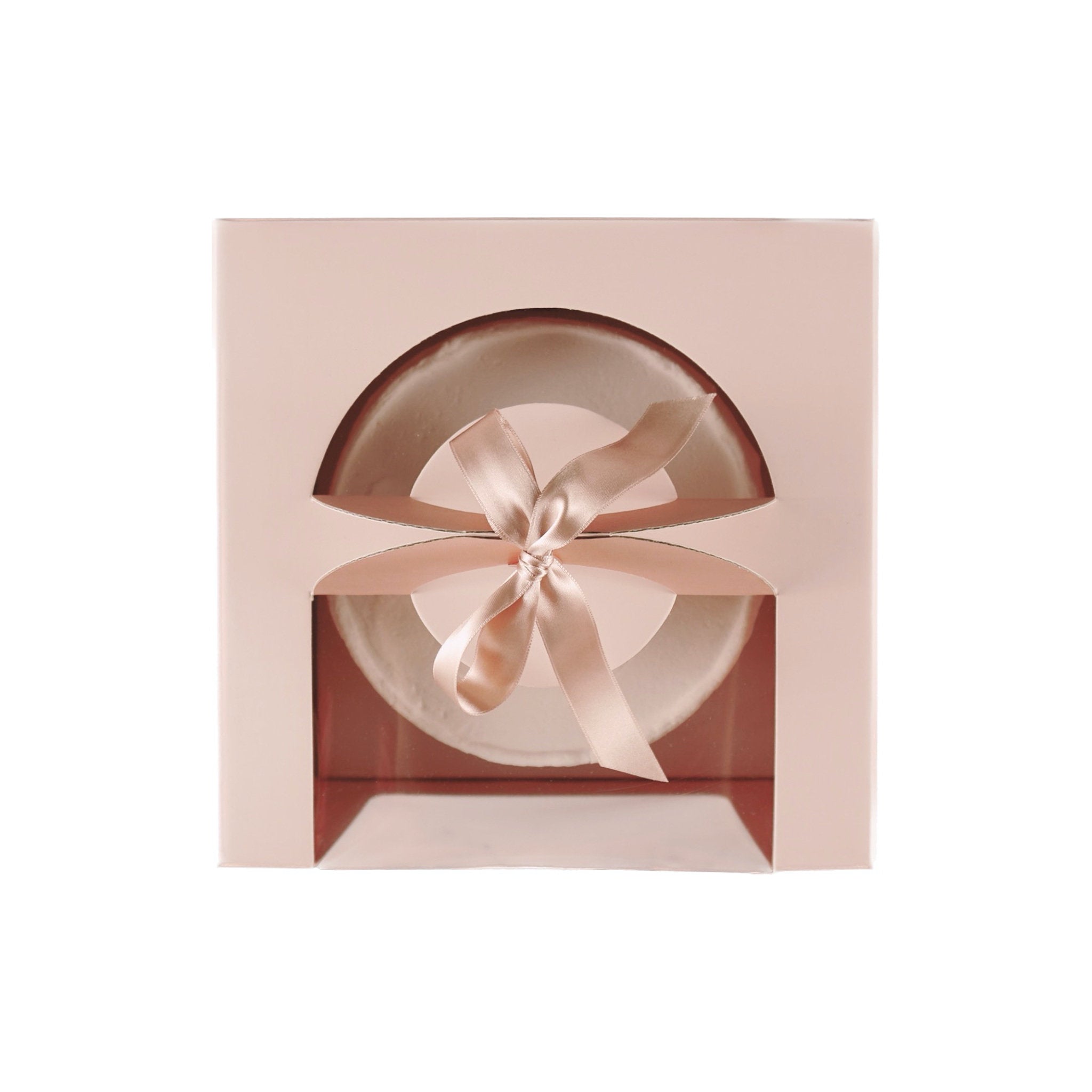 A pink cake box with a clear window, revealing a white cake with a pink satin ribbon tied around it.