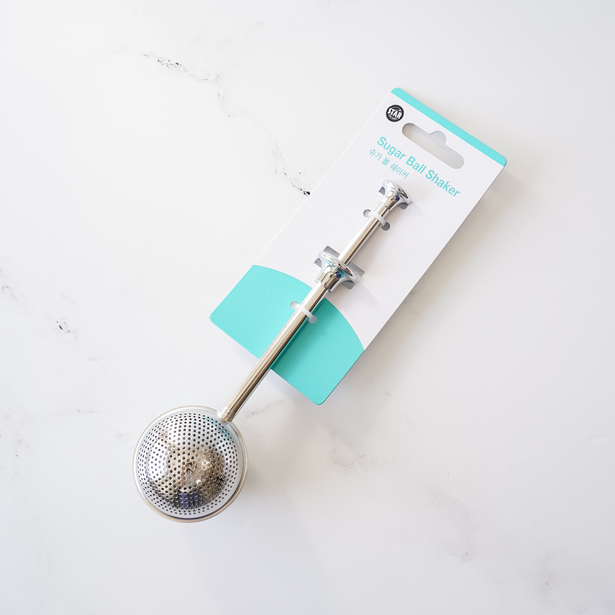A powdered sugar shaker made of stainless steel, shown with a perforated section for dusting powdered sugar.