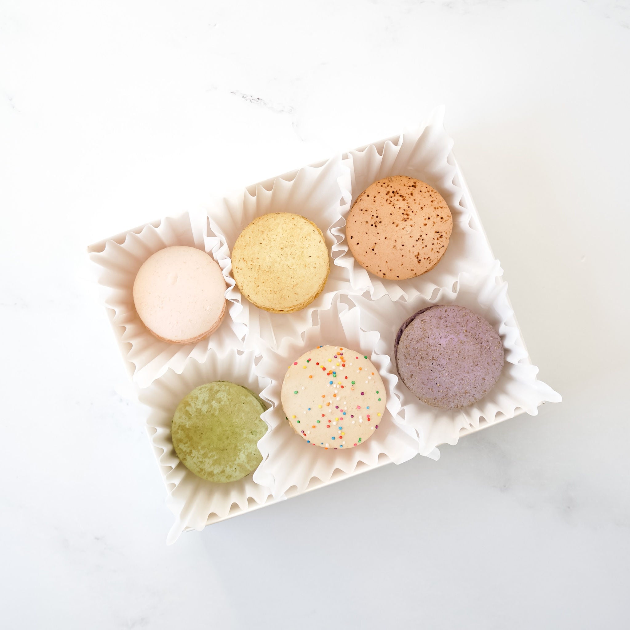 ruffled lotus cupcake liner in white, macaron box