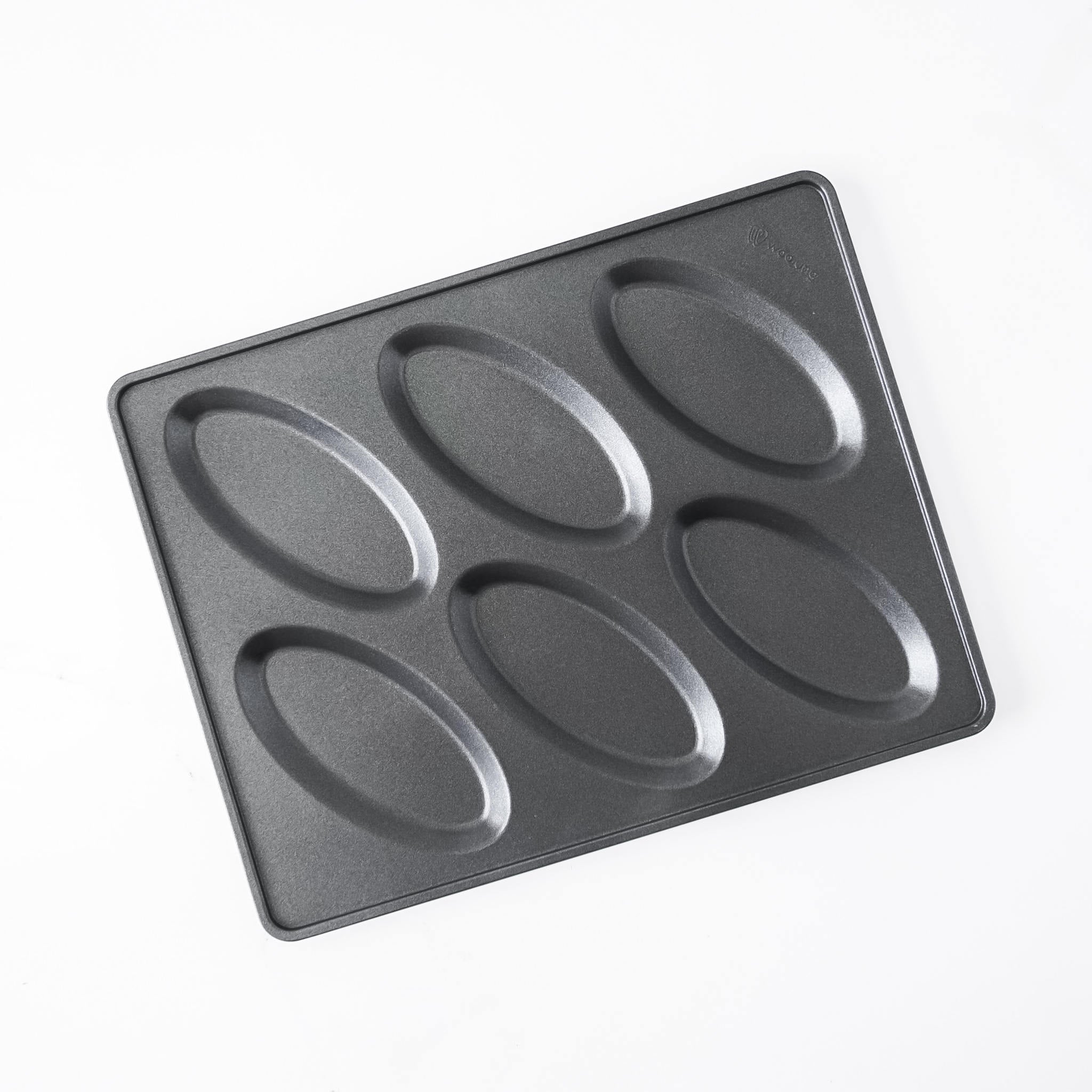 A black non-stick rectangular salt bread pan with six oval-shaped indentations, photographed from an overhead angle on a white background.