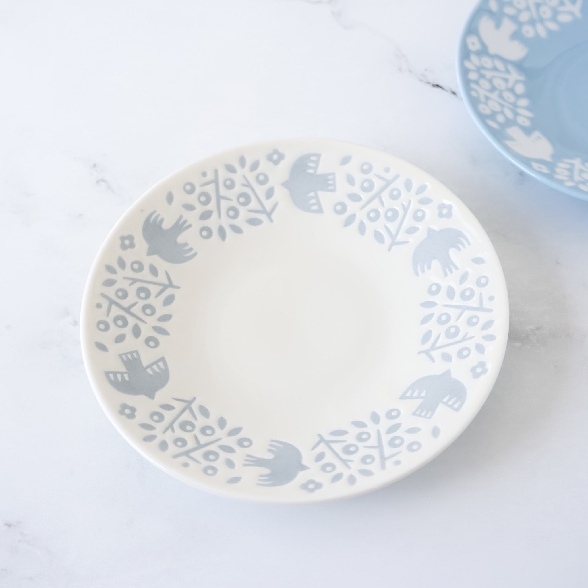 small birds and plants plates in white, blue