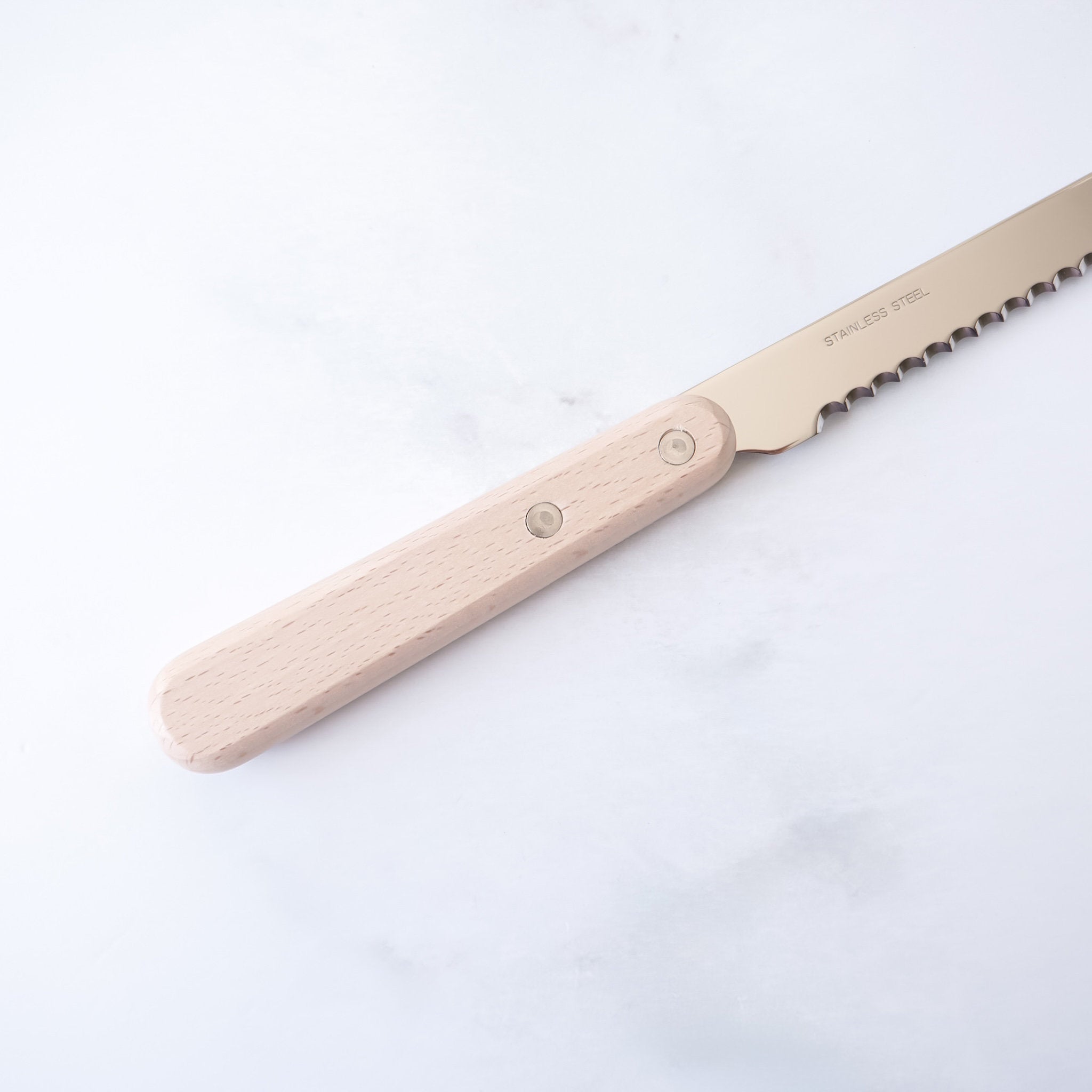 A compact bread knife with a wooden handle and a serrated stainless steel blade.
