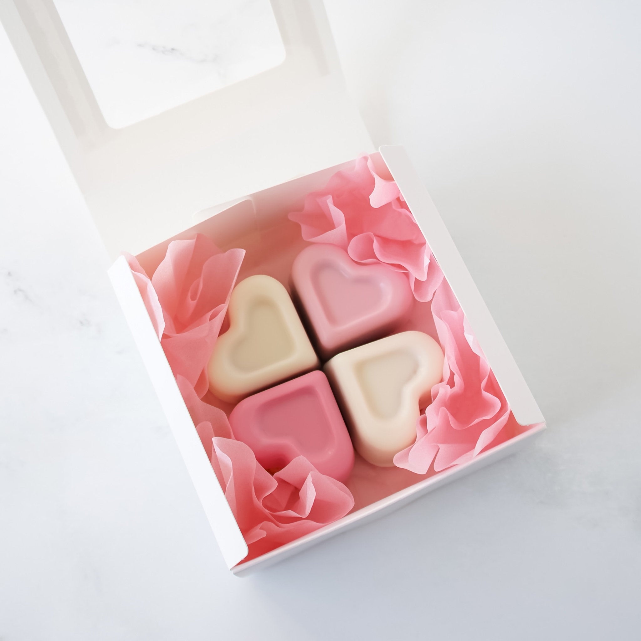 Heart-shaped cookies in a decorative box on a light background