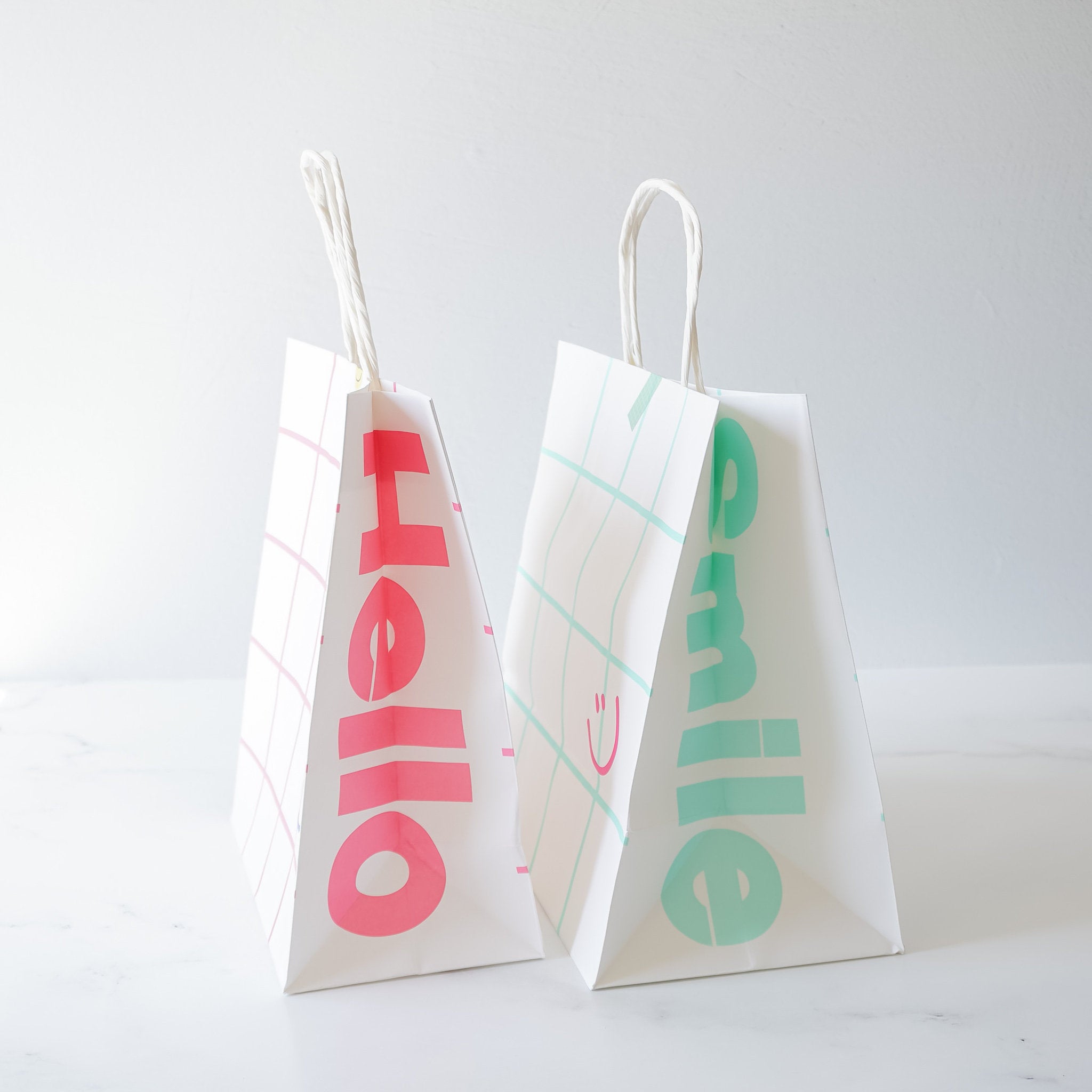 smile printed paper bags in pink and mint