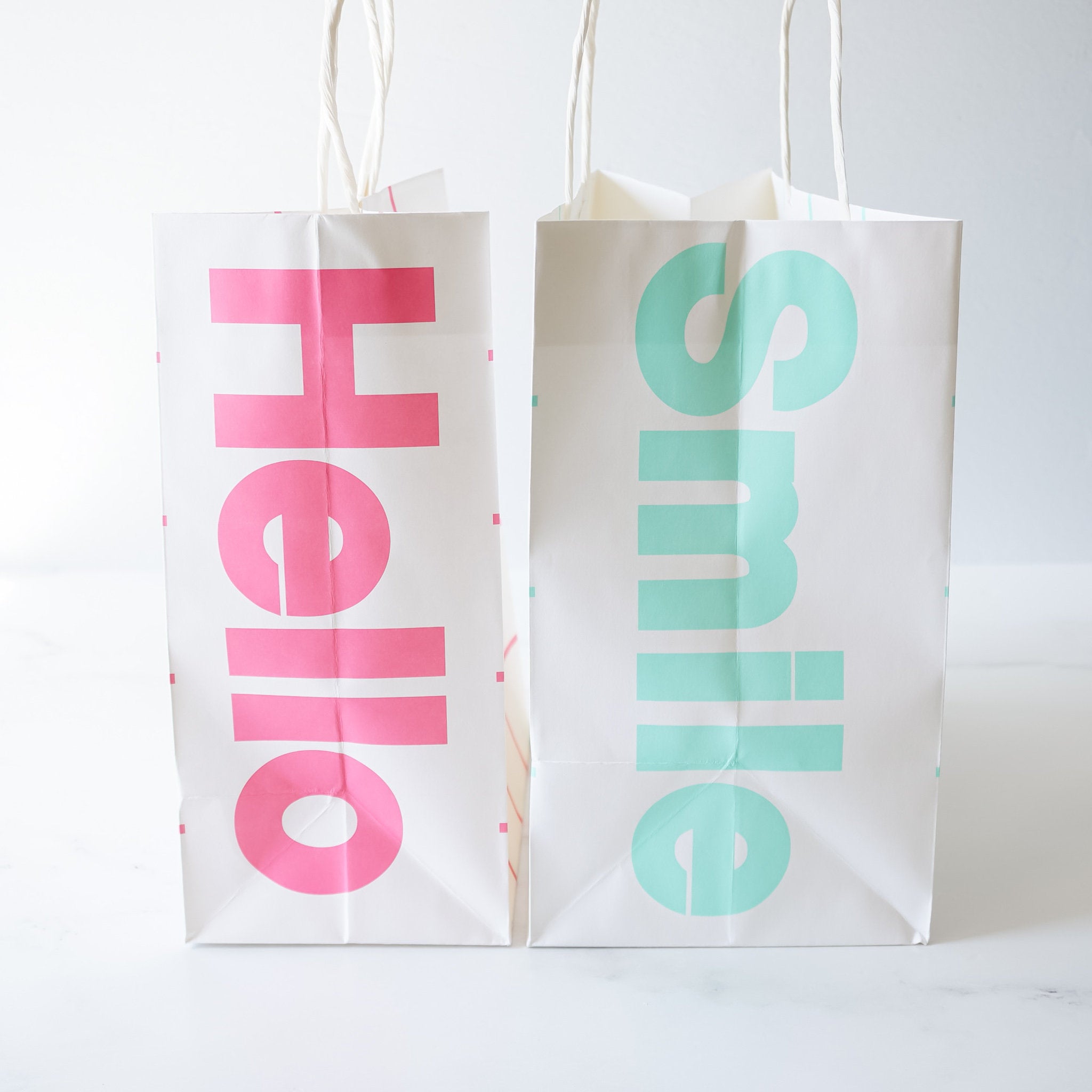 smile printed shopping bags in pink and mint