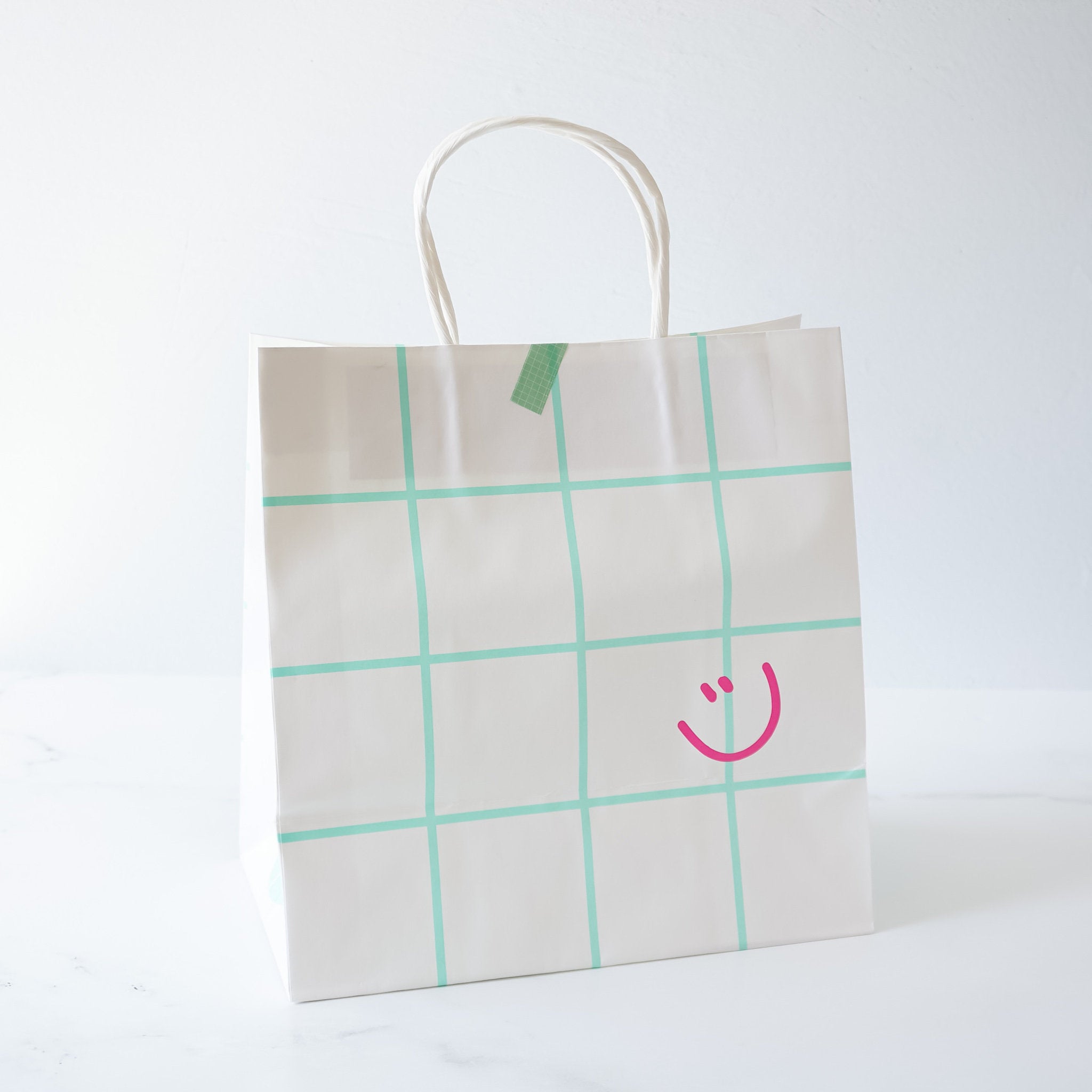 smiley face printed paper bag in mint