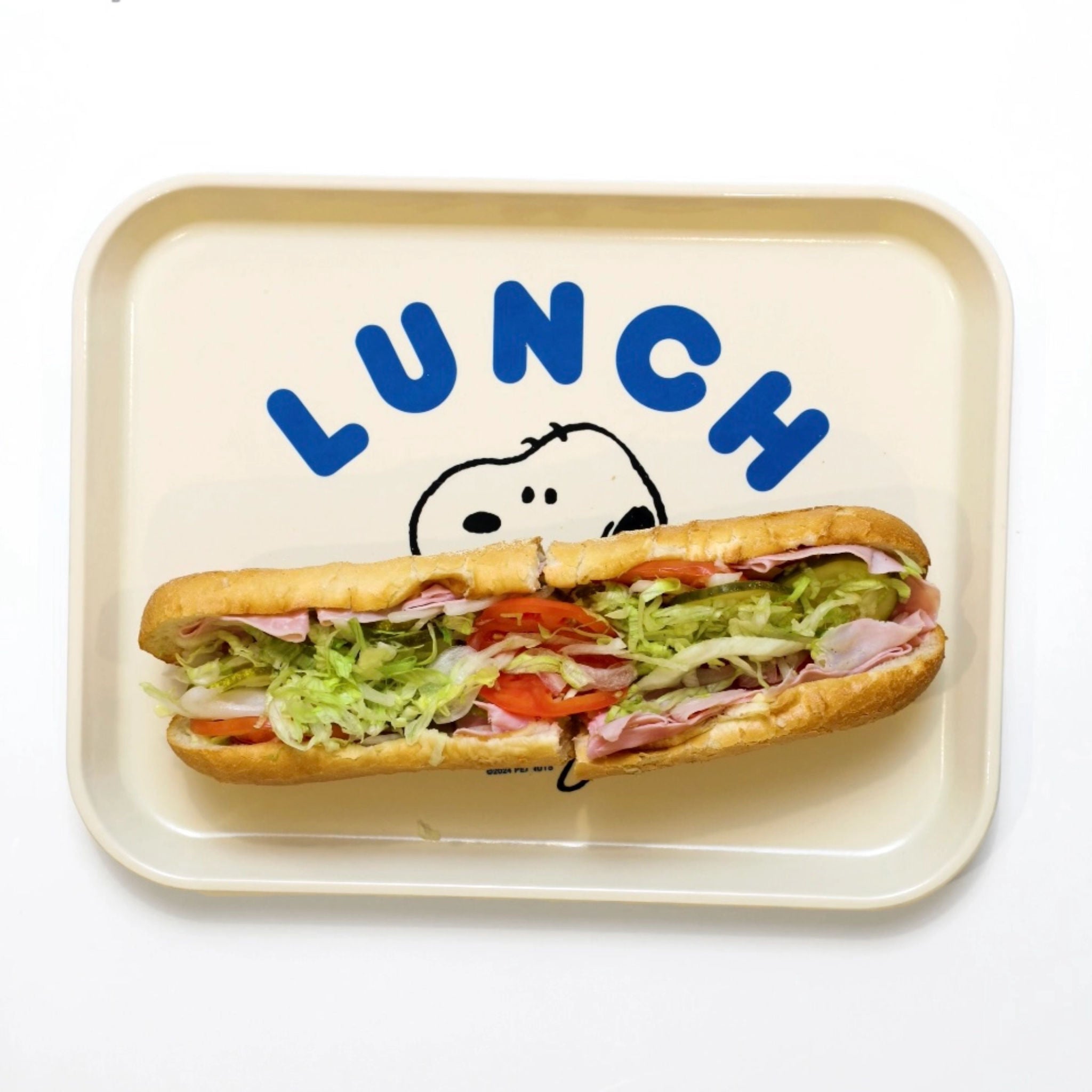Lunch tray with Snoopy and a sub sandwich on a white background