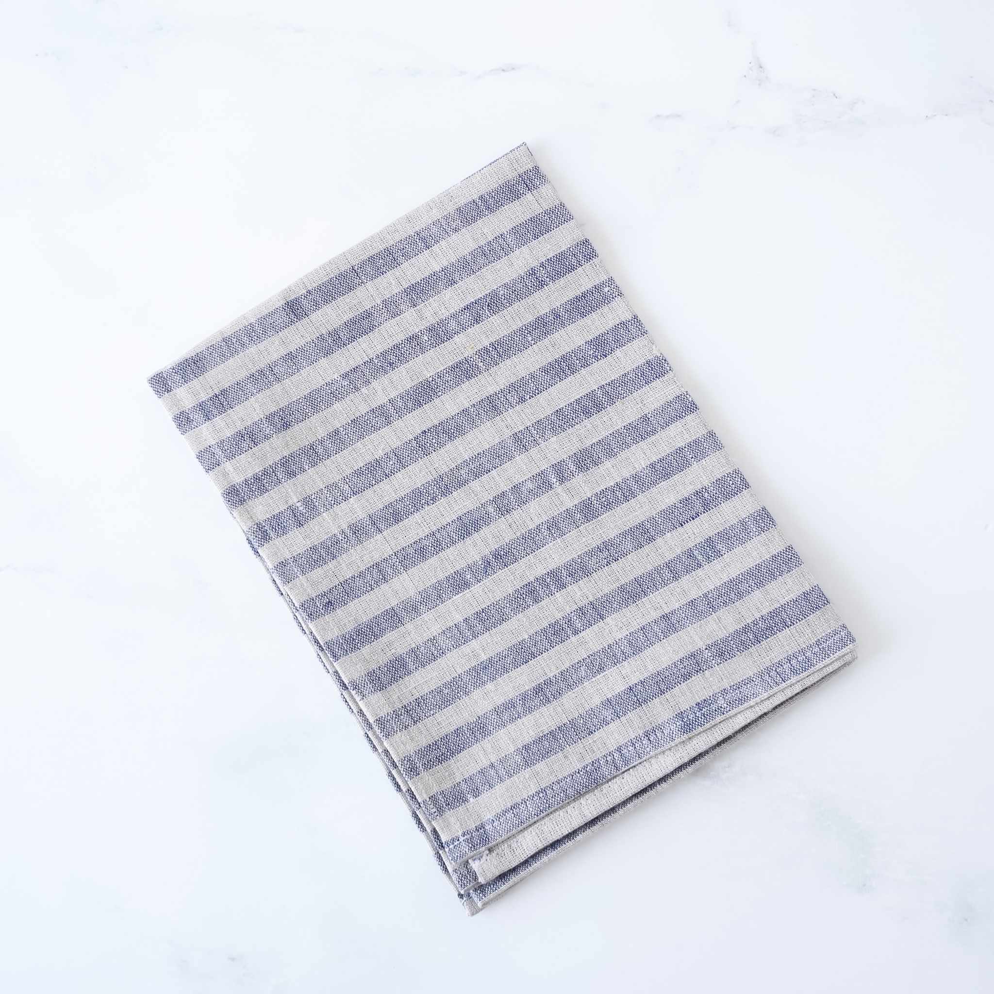 Striped linen fabric dishcloth on a white background