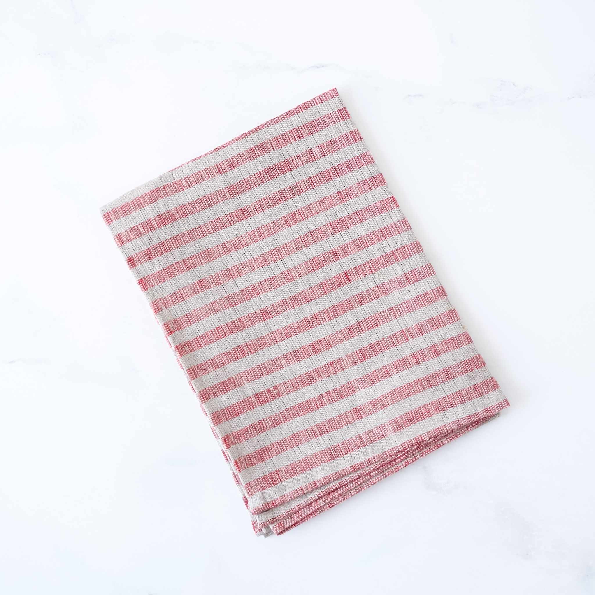 Striped linen fabric dishcloth with red and natural stripes on a white background