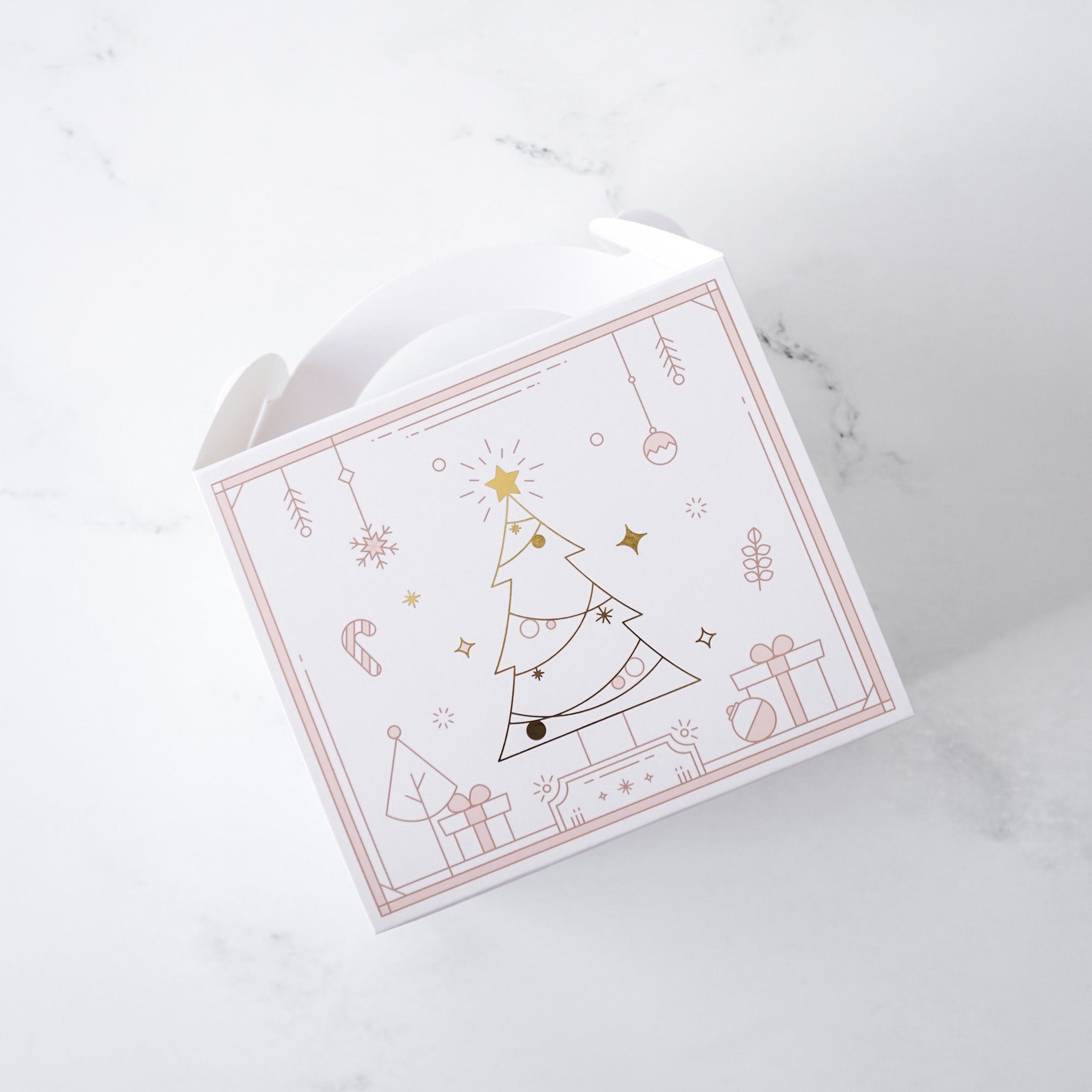 White gable box with Christmas tree design on a marble surface