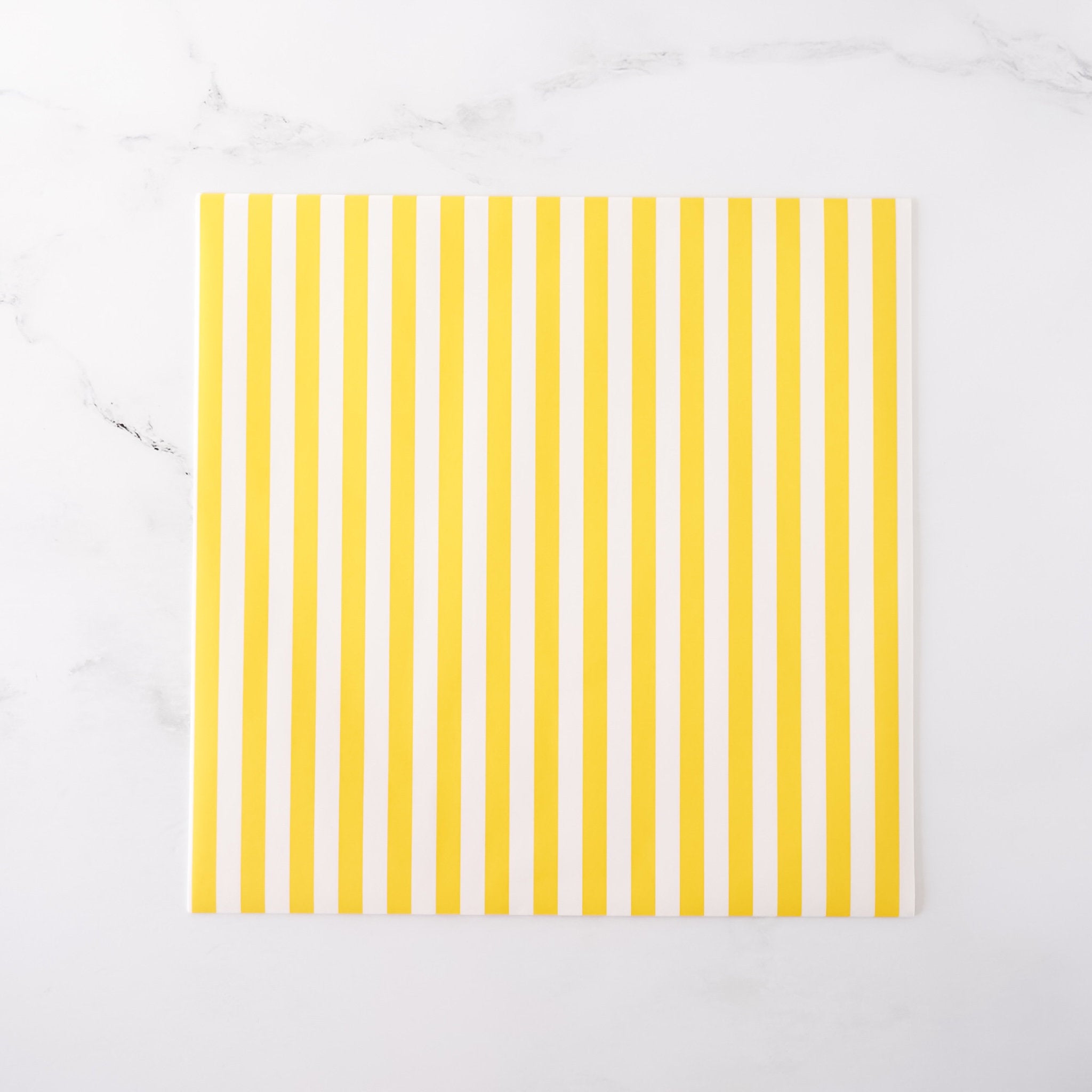Yellow striped deli paper on a white background