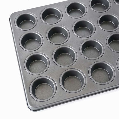 Black muffin pan with multiple compartments on a white background