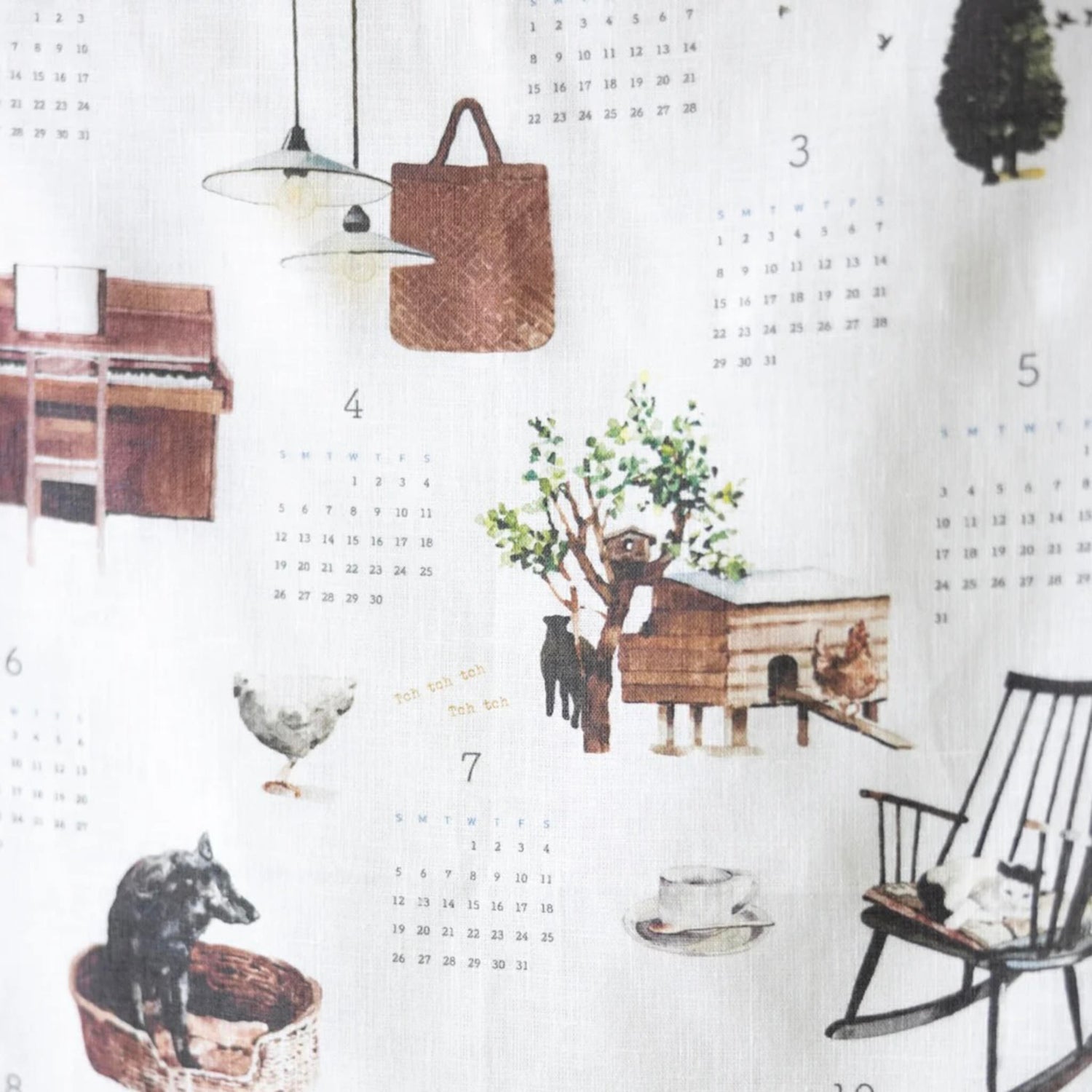 Calendar cloth with illustrations of a dog, cat, bird, and rocking chair on a white background.