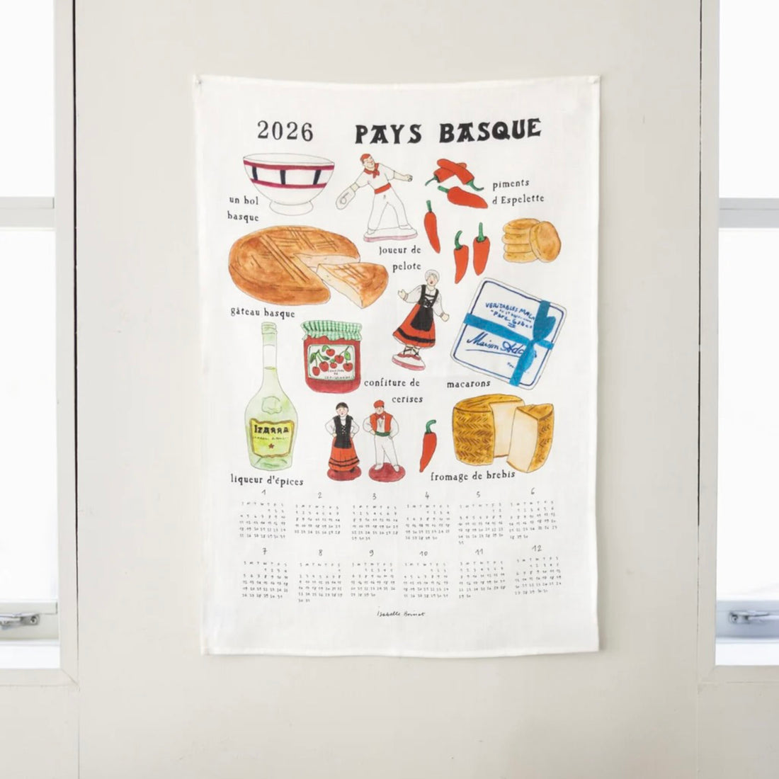 Calendar dishcloth with illustrations of food and culture on a white wall.