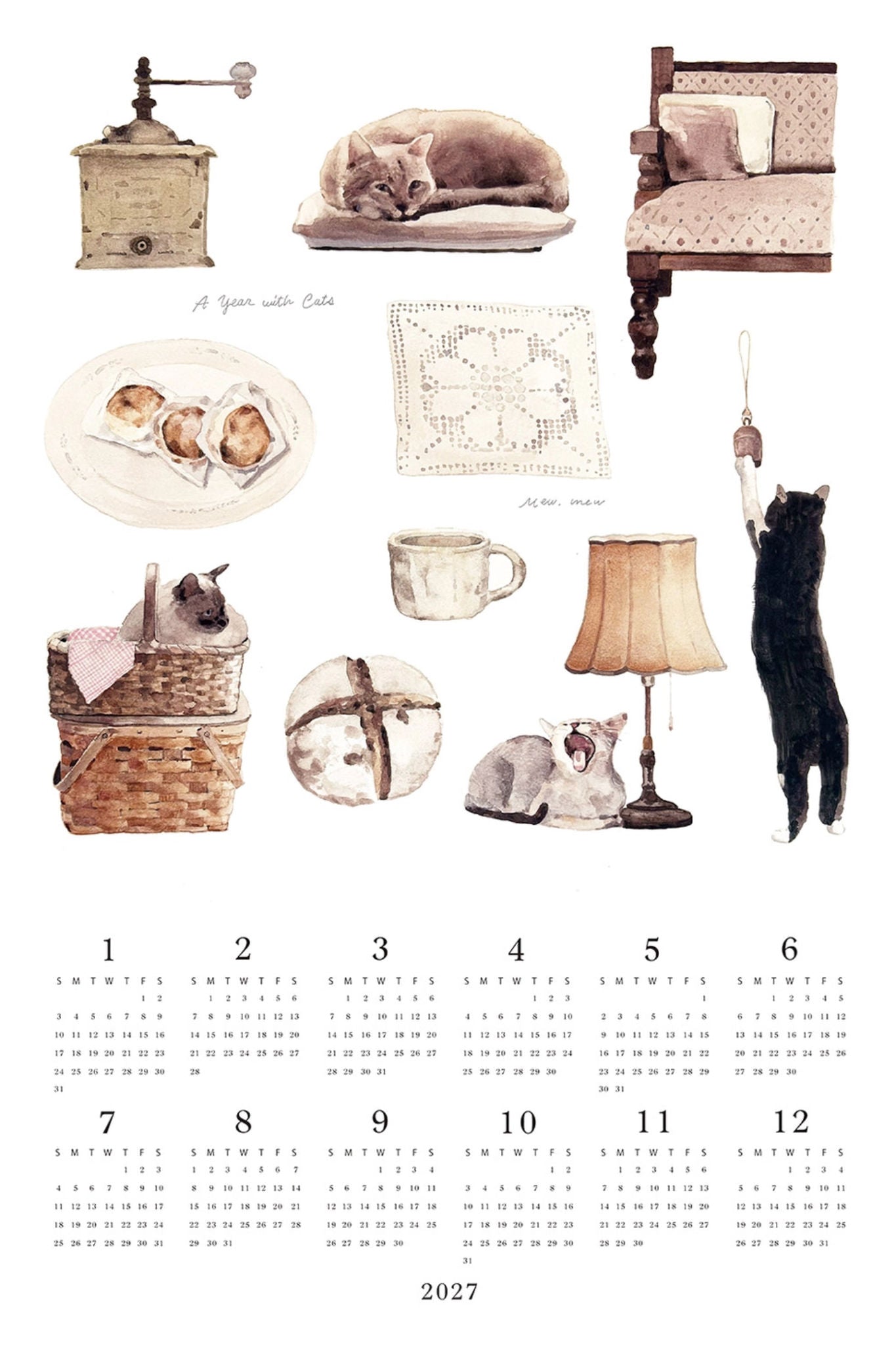 A watercolor-style 2027 monthly calendar page featuring illustrated home objects and several cats in soft pastel tones. The page includes a vintage coffee grinder, a sleeping cat on a cushion, a wooden chair, pastries on a plate, a lace cloth, a teacup, a basket with a cat, a wrapped gift box, a lamp, and a black cat stretching upward.