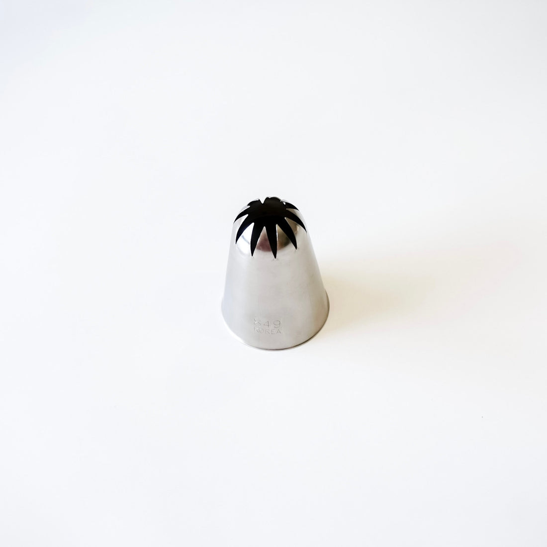 Stainless steel piping tip on a white background
