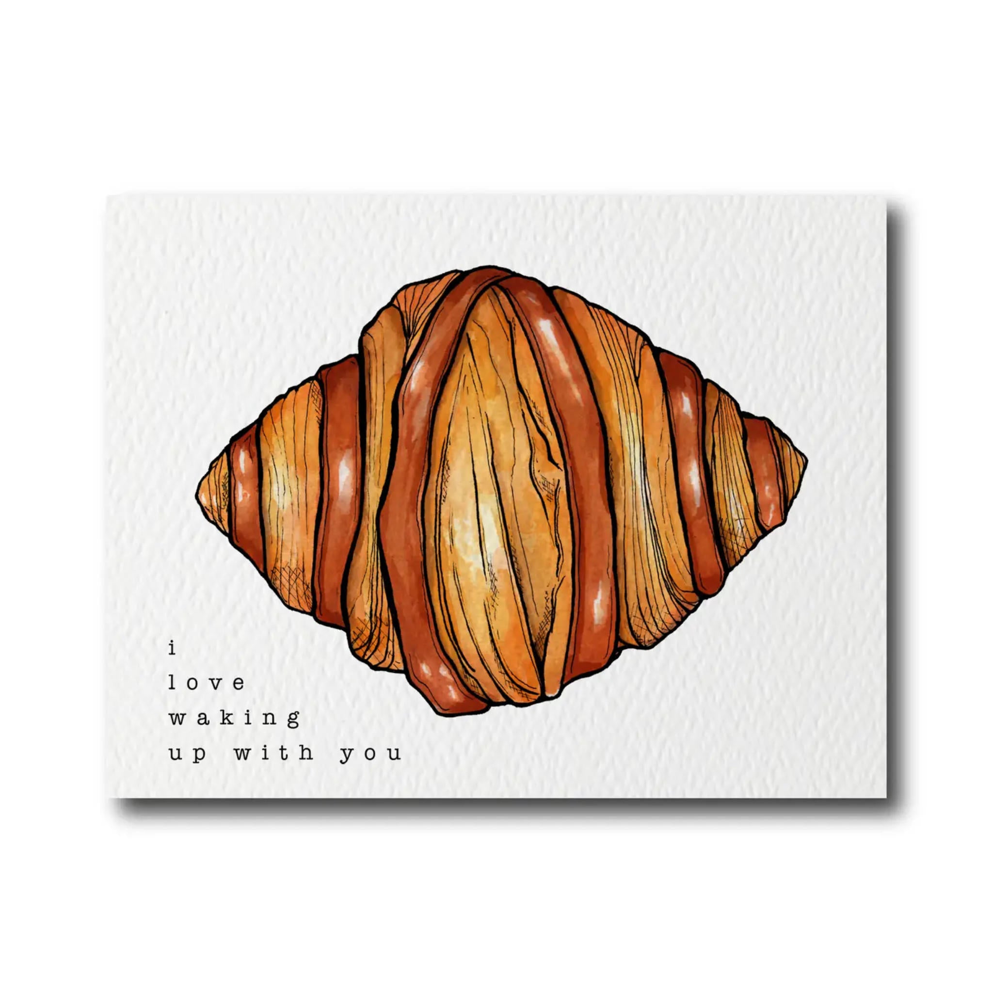 A watercolor and pen illustration of a croissant on a white background with the phrase &
