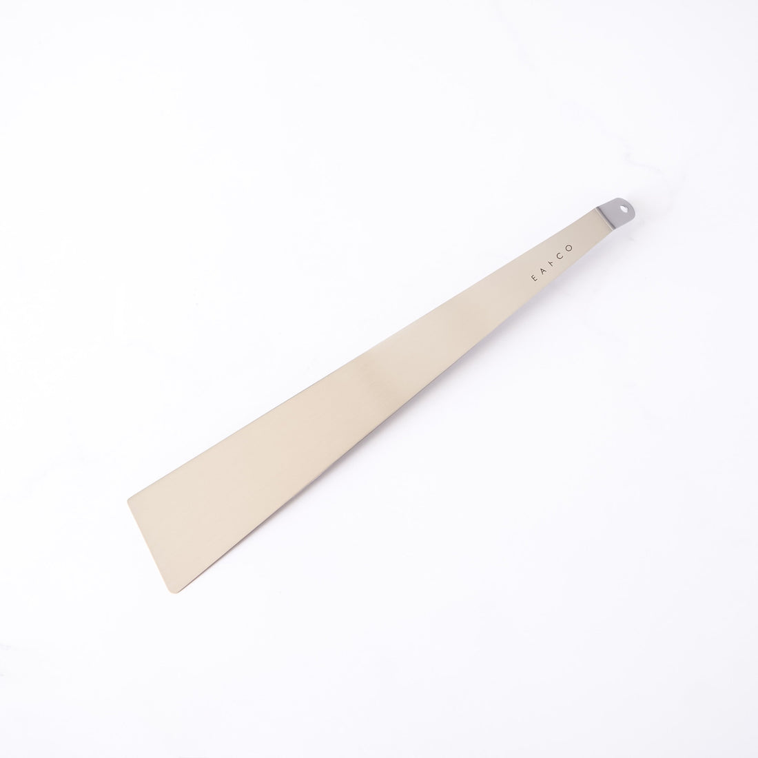 Stainless steel spatula with a metallic handle on a white background