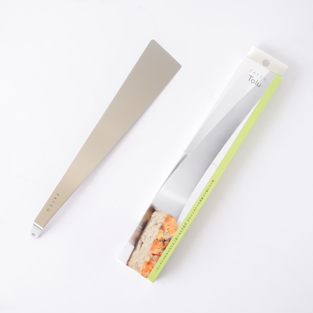 Stainless steel spatula with a metallic handle on a white background