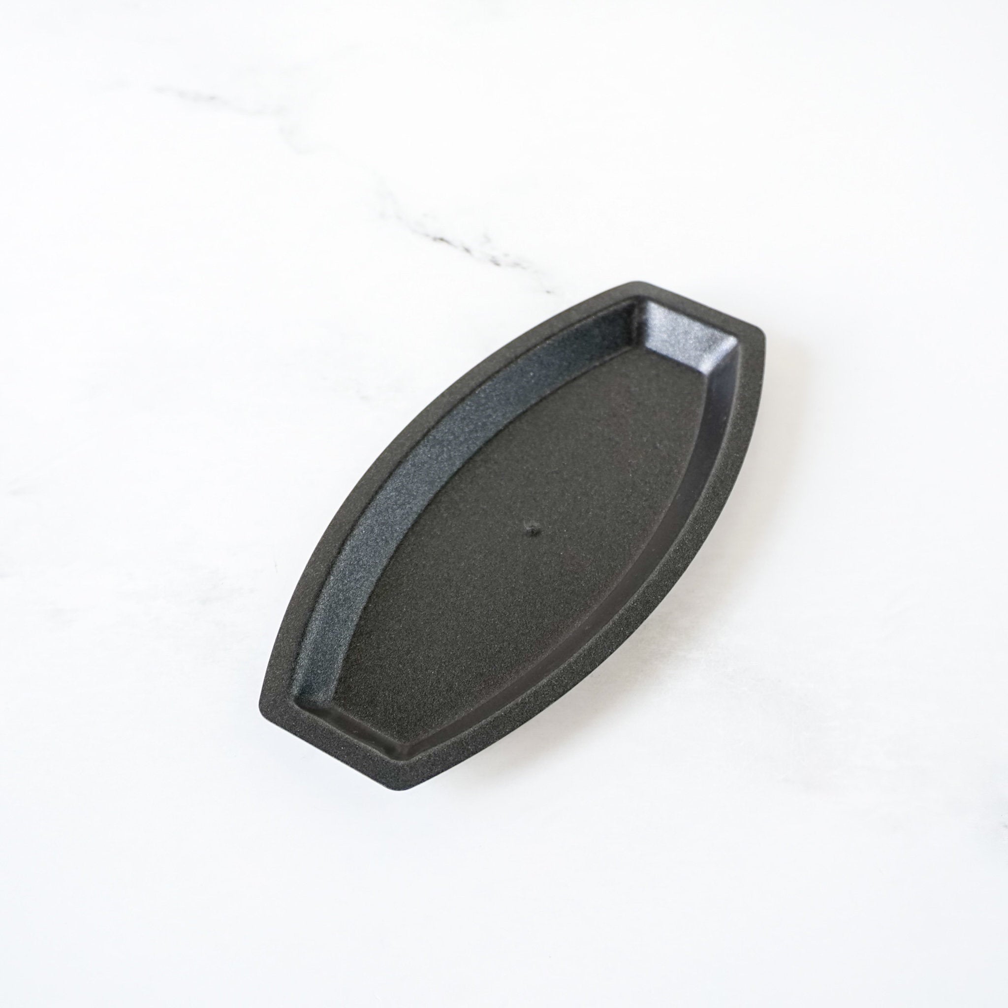 Black metal salt bread mold on a white background