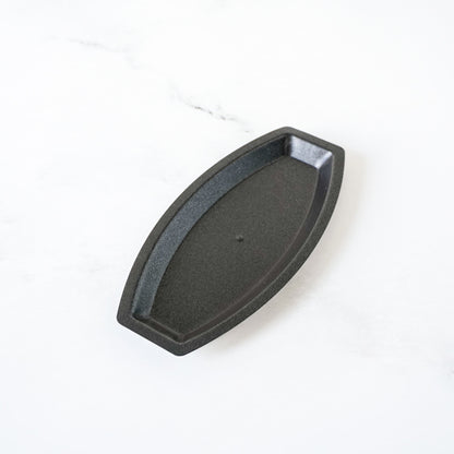 Black metal salt bread mold on a white background