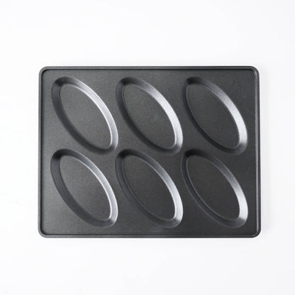A black non-stick six-oval salt bread mold, photographed from directly above on a clean white background.