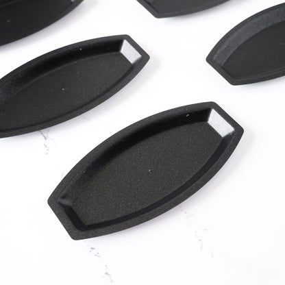 Black salted butter roll molds on a white background