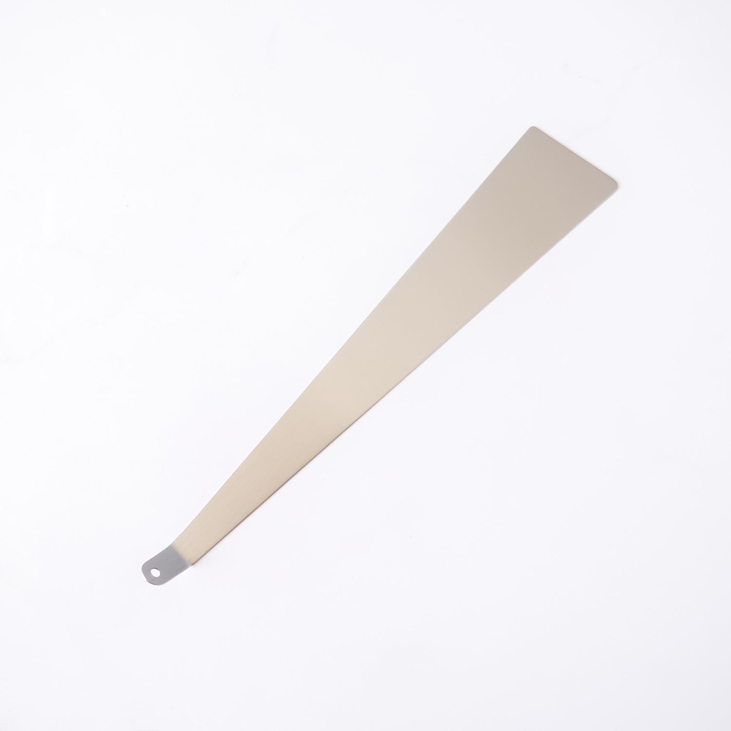 Stainless steel turner with a metallic handle on a white background