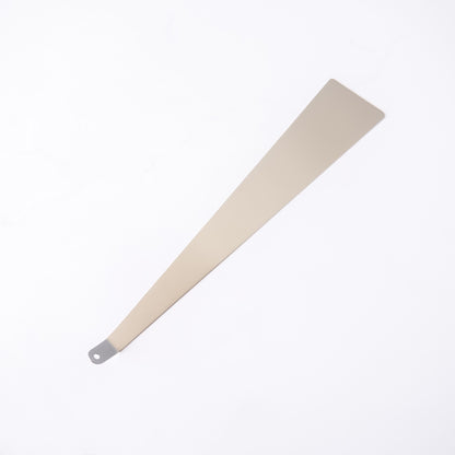 Stainless steel turner with a metallic handle on a white background